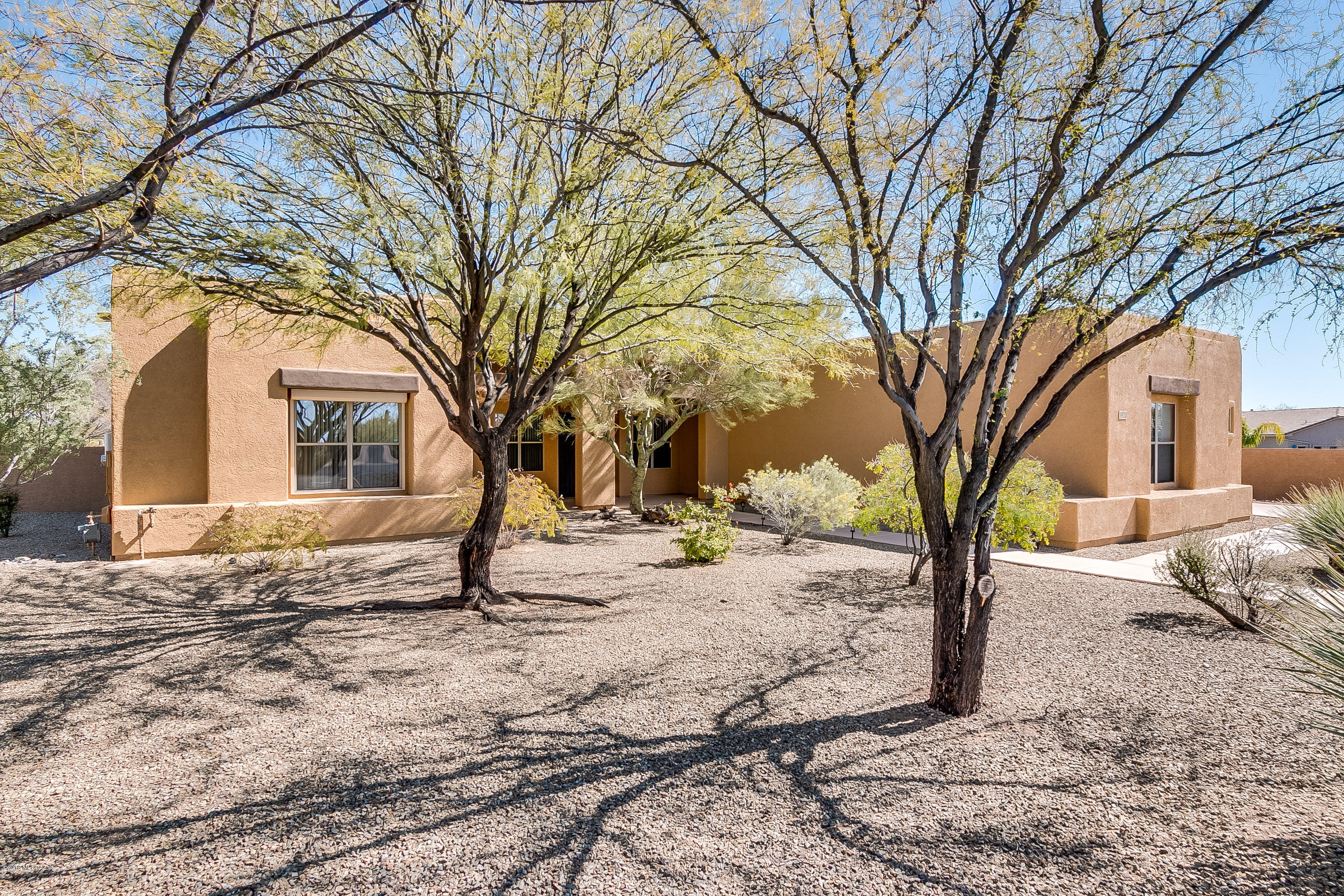 Phenomenal large home with wonderful Pusch Ridge/Catalina Mountain views.  Perfect for a car buff-has a 4 car garage   Special features include 4 bedrooms, den plus office, 3 baths, 20 inch floor tiles, some outside rolling shutters on south and east side, large back covered patio, solar panels to reduce electric costs. Laundry room has cabinets and folding counter.