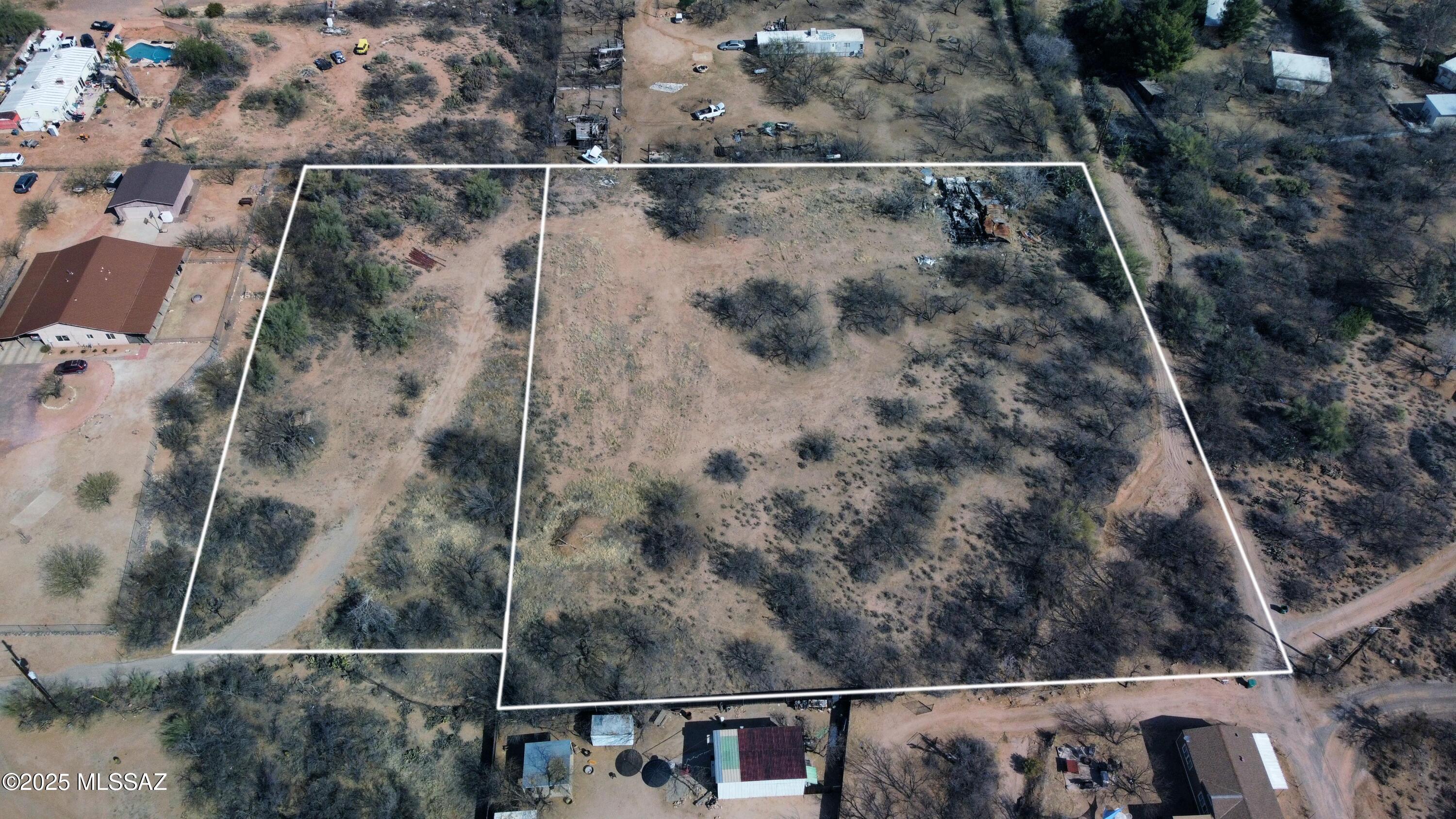 Looking for a lot to place 3 homes on? Great views of the Catalina Mountains.This is a flat parcel that could have up to 3 homes, manufactured or site built. 2 lots adjacent to each other makes a total of 3.3 acres. Seller will remove burnt manufactured home. Property being sold ''As is'' and it will be the responsibility of the Buyer to obtain information about any utilities. Seller will not survey. No HOA so bring your toys and enjoy.
