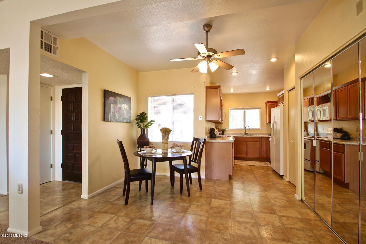 Wonderfully updated Townhome in the desirable Wrightstown Road area of NE Tucson. Spacious Great room floor with fireplace is open to Dining area and kitchen, lots of windows and skylights throughout for plenty of natural light. Brand new carpet. Updating includes beautiful new kitchen cabinets and countertops, sink and fixtures, newer stove and dishwasher. All appliances included.  Owner's bedroom has a walk in closet and private access to the back patio.  Second bedroom is also a generous size. North facing back enclosed patio area with gate and walkway just a few steps away to the community pool area. Double carport and storage in the front of unit.This is a well kept, peaceful complex with great pride of ownership.  Must see!