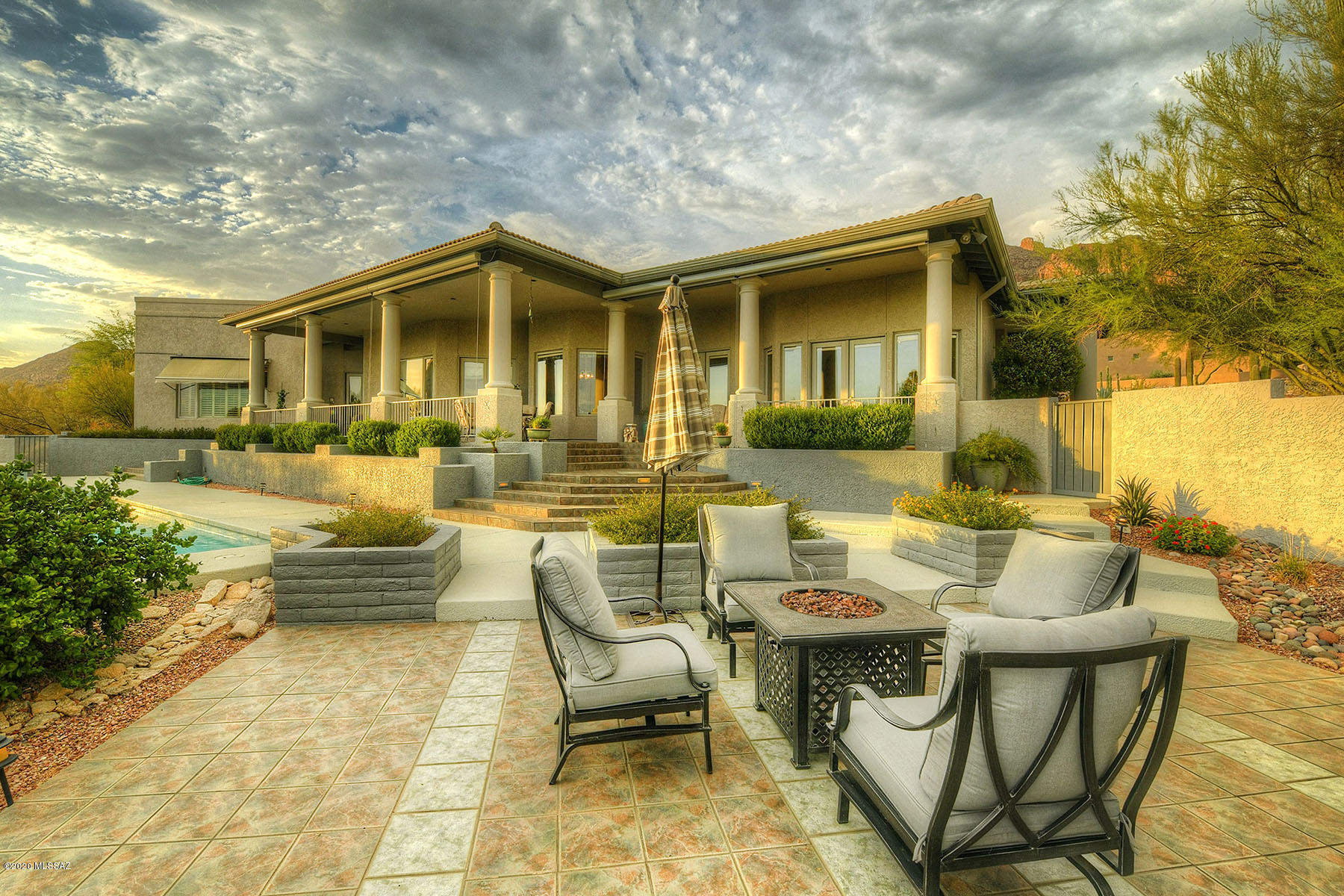 Spectacular city lights will WOW you!  Guard gated & secluded, nestled in popular Camino Sin Vacas, on an elevated lot. Well thought out floor plan has formal living, dining space that opens to back patio & family room with cozy fireplace. Cook's kitchen offers Sub Zero refrigerator, prep sink and plenty of counter & work space. Generous master suite has quiet retreat area with dual fireplace, spacious bath featuring jetted tub, 2 walk-in closets, double vanities with  private courtyard to enjoy the fabulous mountain vistas. Pella windows & doors throughout, central vac too! Extra craft/office, storage and huge garage with attached cabinets. South facing incredible outdoor entertaining space with long covered patio, remote sun shades, pool/spa and the best views around.