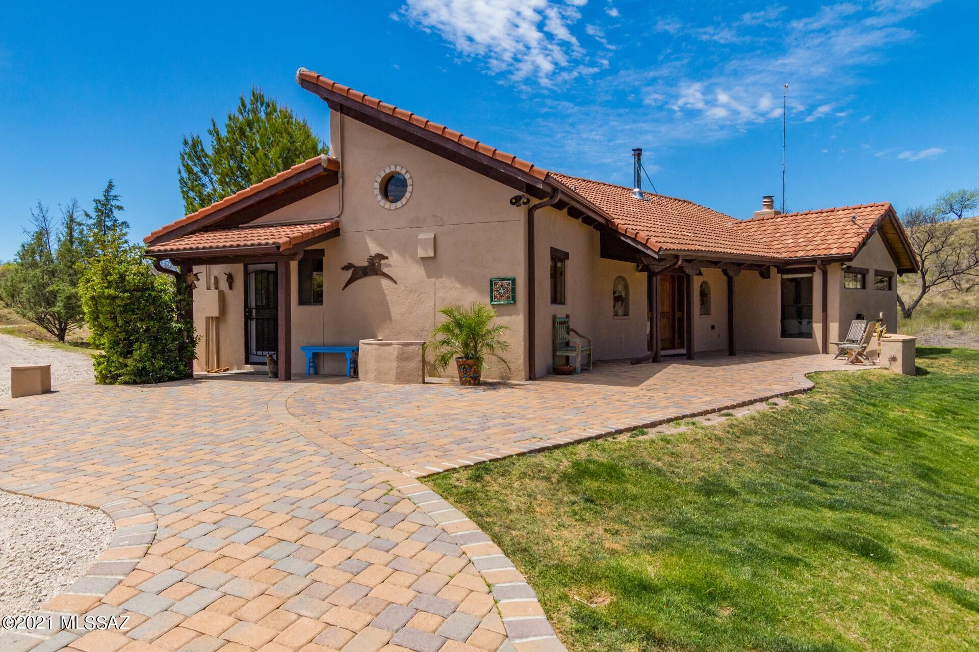 A truly one-of-a-kind 10 acre southwestern gem in the lush desert of charming Arivaca, Arizona. This private sanctuary is the paragon of sweeping landscapes and quiet outdoor living, perfect for horse owners and avid hunters alike. Walking along the winding path of pavers, you'll find this property has been revamped with no expenses spared, offering an ample list of amenities. Enter in through the custom-made Tumacacori Mesquite entry door into the spacious living room, you'll immediately notice the vaulted ceilings, rustic beams and gorgeous hand-laid stone floors. The master bedroom offers plenty of space, along with it's own fireplace to keep you warm in the winter months The master bath features a double vanity with a thermostatic shower and claw foot bath tub to soak in after a long day. This stunning gourmet kitchen is graced with custom quartz counter tops & back splash, GE appliance package and custom made cabinets. Outside the main house along the path of pavers, lies a detached remodeled guest casita with a covered Vega beam patio and Kiva fireplace. Separately, a renovated music studio or office, offers endless potential for guests and personal hobby's.
For all you horse lovers, this property features a custom built Curt Boyd horse stables with 4 stalls, insulated tack room, hay storage and ceiling fans. Additionally, this property features an incredible 170' x 90' fully irrigated sand footing horse arena, made with all Priefert quadraform premium panels. In addition, it's accompanied with a 60 foot Priefert round pen that is also fully irrigated with sand footing. Full RV hookups and covered parking, this property truly has it all. 

HUGE plus!: 
Repavement of many main roads just finished!