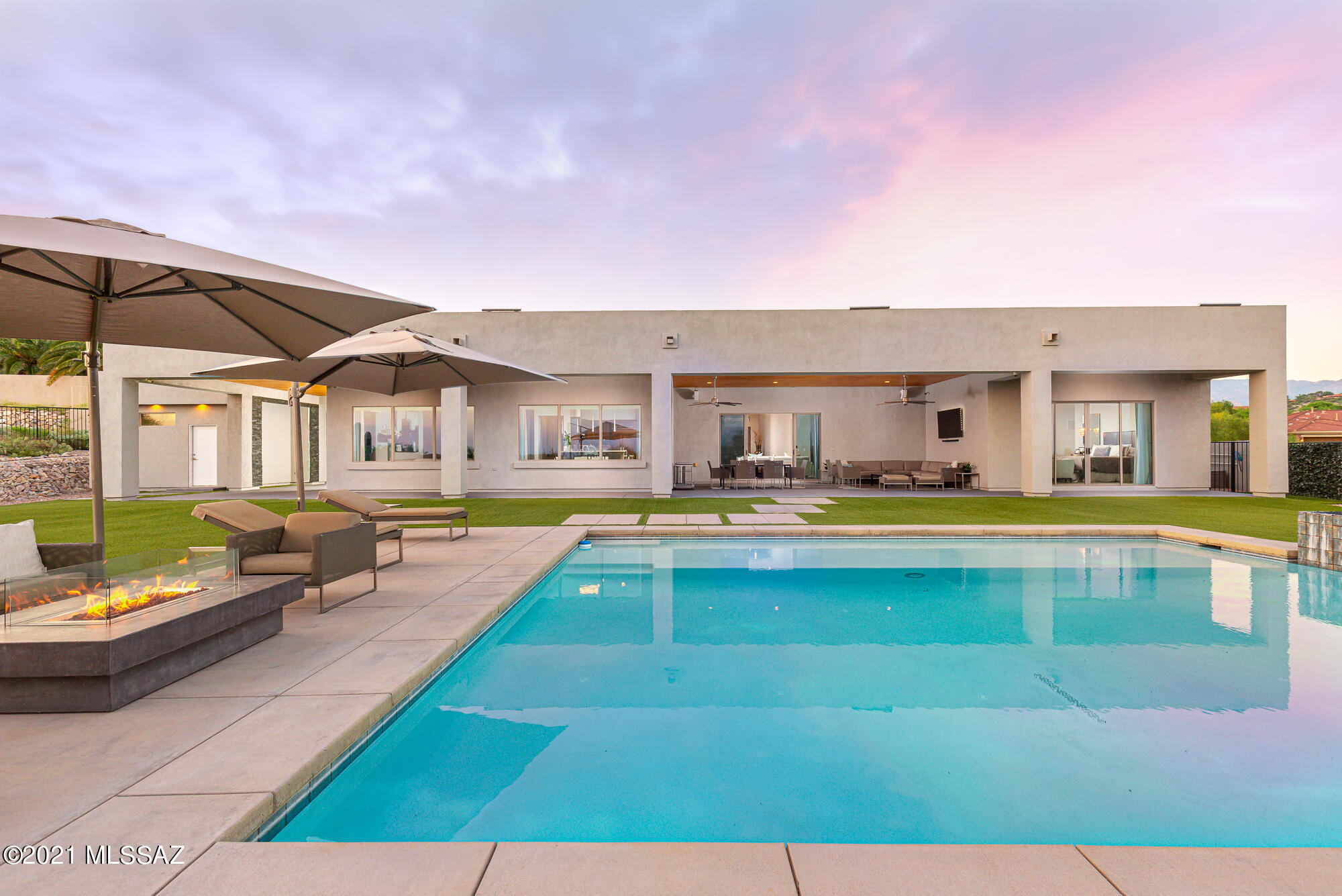 Exquisite custom contemporary built in 2013, located in the highly desirable gated community of River Gate Estates. If you have been looking for a newer home in the Catalina Foothills, this is the one. Impeccably maintained, timeless design in one of the most coveted locations in Tucson. Perfectly designed for grand scale living, and a seamless integration between interiors and exteriors.

The exterior features extensive covered patios, Bose sound system, saltwater pool and spa with a full outdoor bathroom. Endless unobstructed city and mountain range views can be enjoyed from every angle. 

Interior features include four bedrooms, a flex bonus room all with en-suite bathrooms. Grand formal and informal living spaces. A chef's kitchen that includes Miele and Sub-Zero appliances. 

Thoughtfully designed smart home integration wired with a security camera system, pre wired for motorized shades and surround sound in select areas, solar water heater, smart thermostats, MyQ, exterior sound system, surround sound in master bedroom, 220V hookups and three Tesla charging stations. 

Nearby amenities include: Whole Foods shopping plaza, Basis school, restaurants, Rillito River bike path known as "The Loop", and more!

Schedule your appointment today.