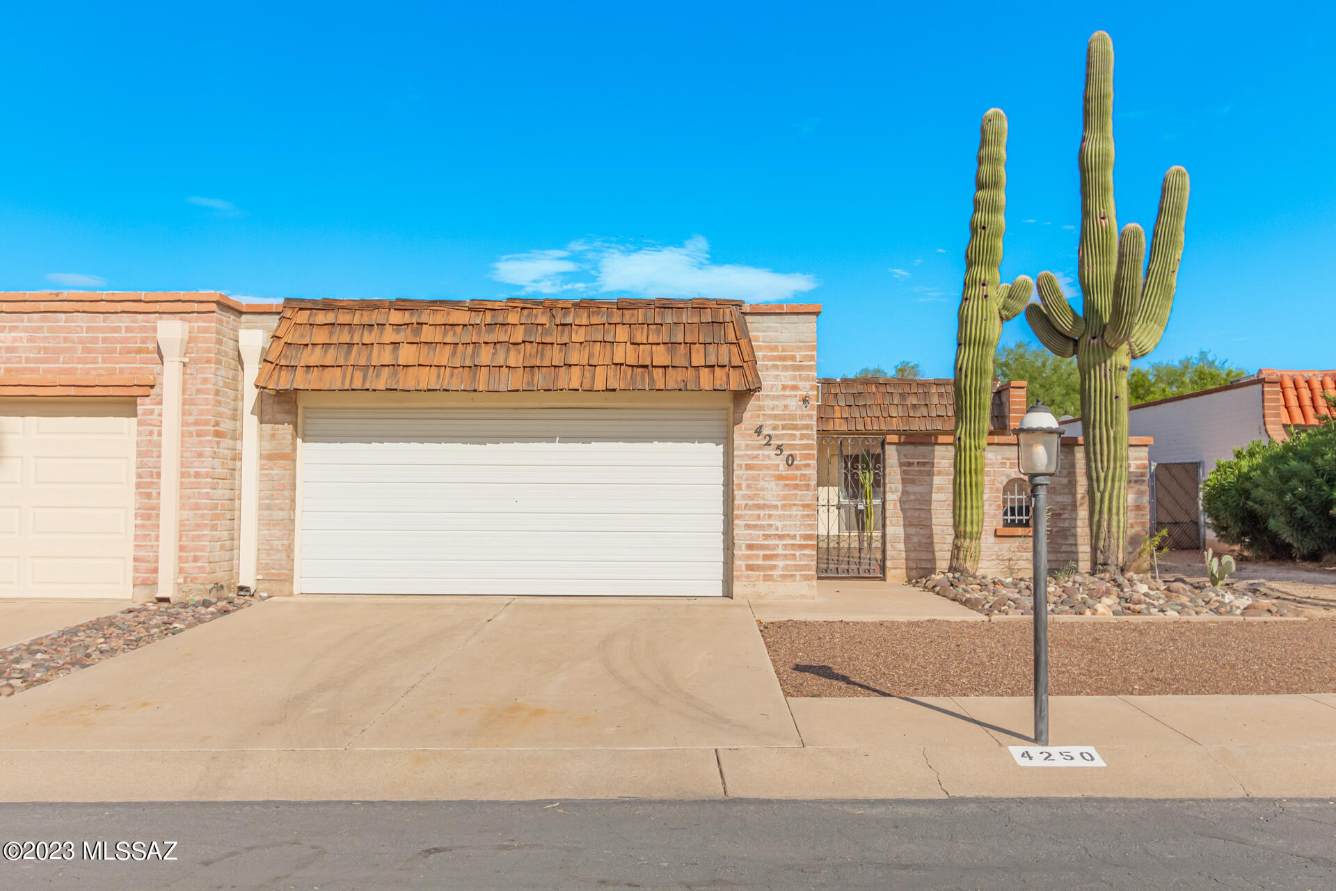 Discover the epitome of easy, single-level living in this inviting townhome in Tucson! As you enter through the gated courtyard, you'll immediately sense the privacy and charm it offers. Combined living & dining room seamlessly connects with the outdoors through sliding glass doors leading to the back patio. The kitchen features built-in appliances, pass-through window, plenty of cabinet space, and tile backsplash. The main bedroom boasts a mirrored door closet, outdoor access, and a private bathroom with a walk-in tub. PLUS! Additional bonus room that can be converted into an extra bedroom for your guests. In the backyard, a covered patio provides a shady spot for outdoor gatherings, and a storage shed keeps your belongings organized. Turn-key home is ready to welcome you! Owner/Agent