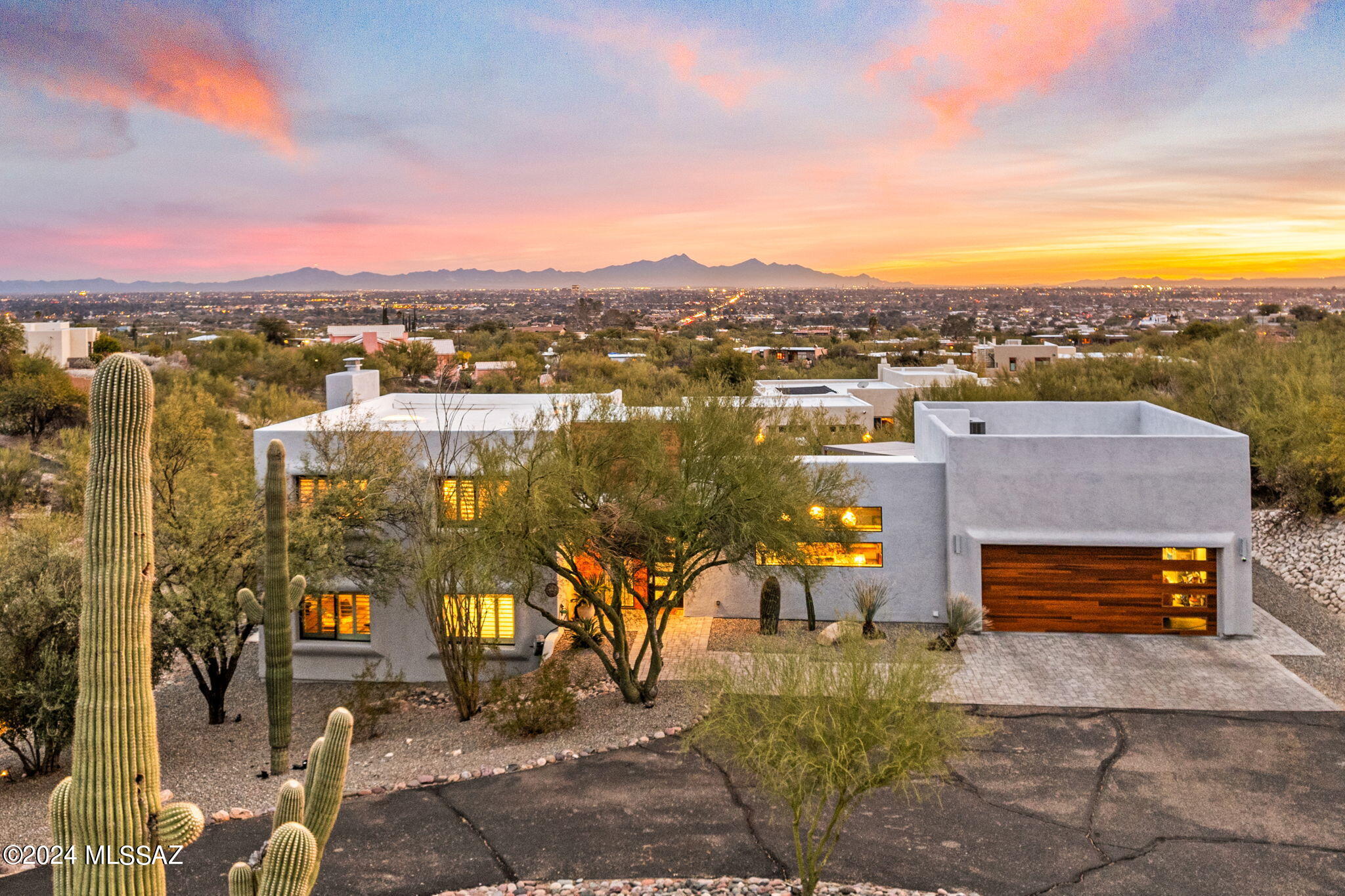 Modern Masterpiece! Featured in Tucson Lifestyle, this bespoke Foothills home sets a new standard for luxury, style, function, and design! Lovingly remodeled and tastefully executed, this is the dream that you have been looking for! Arrive in style with stunning curb appeal to the epitome of desert modern living! Walk into a grand entryway with views for days and the great room which overlooks the twinkling city lights. The kitchen is a chef's dream with quartz, natural light, custom cabinetry, extended island, and designer touches. The dining area blends seamlessly and the whole space just works for function and flow. The primary suite is a true retreat with private patio overlooking the city, spa like bathroom, and walk in closet. The guest bedrooms are spacious and comfortable... Downstairs, you have a media/flex room with private patio and additional bedroom suite. Have your own resort style backyard with pool, patio space, built in grill and pergola, turf, water features and pristine views over the valley below! Don't miss the office nook, pool bathroom, and extra details galore. Turn key luxury executed to perfection! Foothills desert modern luxury at its finest here. Welcome home!