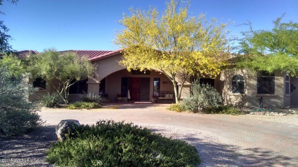 Beautiful southwest Tuscan faade with cobblestone driveway welcomes you to this large custom home boasting 3 bedroom suites, pool & privacy bordering a vast arroyo with open views all the way to the Catalina Mountain Range in Tucson. Grand foyer, formal living and dining rooms with coffered ceilings, den/office off living room, another den in one of the guest suites, both with access to outside, gourmet kitchen in great room with windows looking out to the pool and views. Back yard features covered porch, vegetable garden area or putting green adjacent to built in BBQ area, bar and hot tub pad. Did we mention the new ceramic tile and carpet in bedrooms? What about the luxurious master bath? There is just too much to list on this well placed home on .82AC. Call agent for a personal viewing