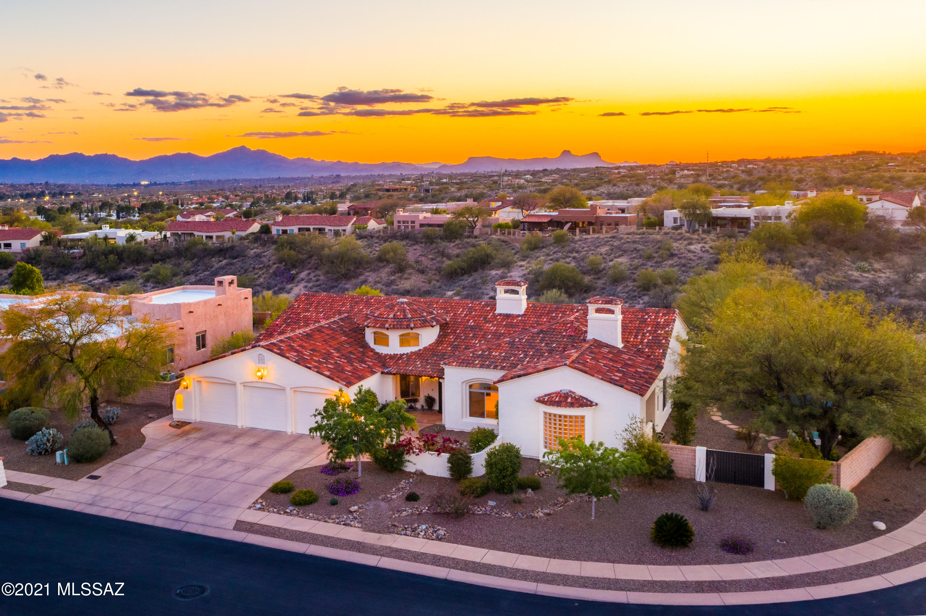 A Spectacular Santa Barbara! Welcome to gated luxury in the heart of Oro Valley! This Sombra built home is quality throughout! Elegance abounds with gorgeous travertine, cherry cabinets, Pella windows, solid granite counters & custom iron work gates. The layout is perfection including a grand entry, open concept kitchen, and split bedroom plan! Don't miss the stunning formal dining room tongue & groove rotunda! The expansive master bedroom is a true retreat w/ cozy lounge area and fireplace! The master bathroom feels more like a luxury spa! The manicured backyard boasts stunning sunset views, stylish pool with waterfall, fire-pit, BBQ, flagstone, and even a north patio for mountain views! No neighbors to the north so the lot delivers extreme privacy! Don't miss this incredible home!