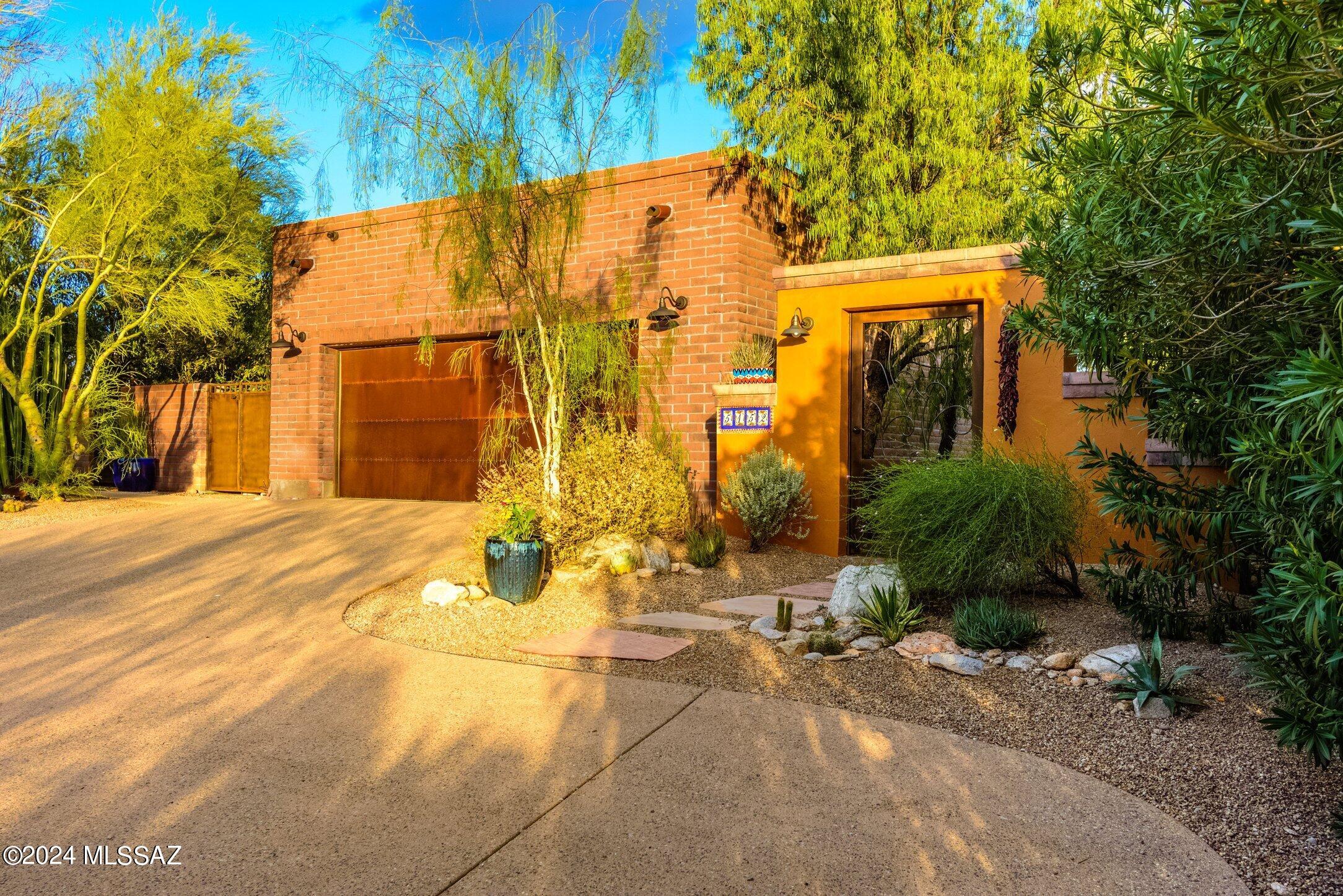 Quintessential Tucson style home, built in 1989  to show full view of the Catalina Finger Rock Canyon. Custom built lap pool, with lush plantings & irrigation throughout yard. Gorgeous newer kitchen w/stainless appliances. Great room windows are 10' high. Most rooms have 10' ceilings w/recessed lighting. High ceilings and loads of natural light on the north facing home. Many skylights, even in garage. Full view of mountains from every room & hallway, French doors to garden & brick patio. 2 red brick covered wood beam porches & outside spotlights.No steps, thick walls, very private & well-insulated.