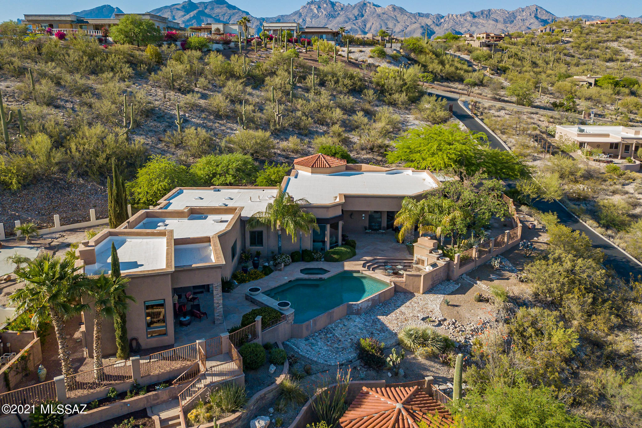Exquisite Mediterranean Contemporary home on 1 acre lot with fantastic Mountain & sweeping city views from the south facing back yard. The 4492 square foot home has been masterfully upgraded with the finest finishes. Home features include split bedroom floor plan with 4bedrooms/4 baths, music room, office, large media room (4th bedroom currently used as artist studio) Gourmet kitchen with massive island with Mahogany kitchen cabinetry, slab granite counter tops & top of the line stainless steel appliances. Master retreat has large master bath with steam shower & jetted tub. Also featuring 3 fireplaces, 2 wet bars, deluxe salt water pool with multiple remote controlled water features & fire pits. Located near Basis School North. Gated Community of 4 homes. Media room has a fireplace, wet bar and wine cooler with views of the pool and separate covered patio. The Outside has a extended covered patio that looks south with sweeping views or the city and Mountains. Large Salt water negative edge pool with spa. Outdoor kitchen with seating area near pool. Lower yard area separately fenced with Gazebo. Many more amenities to offer.
