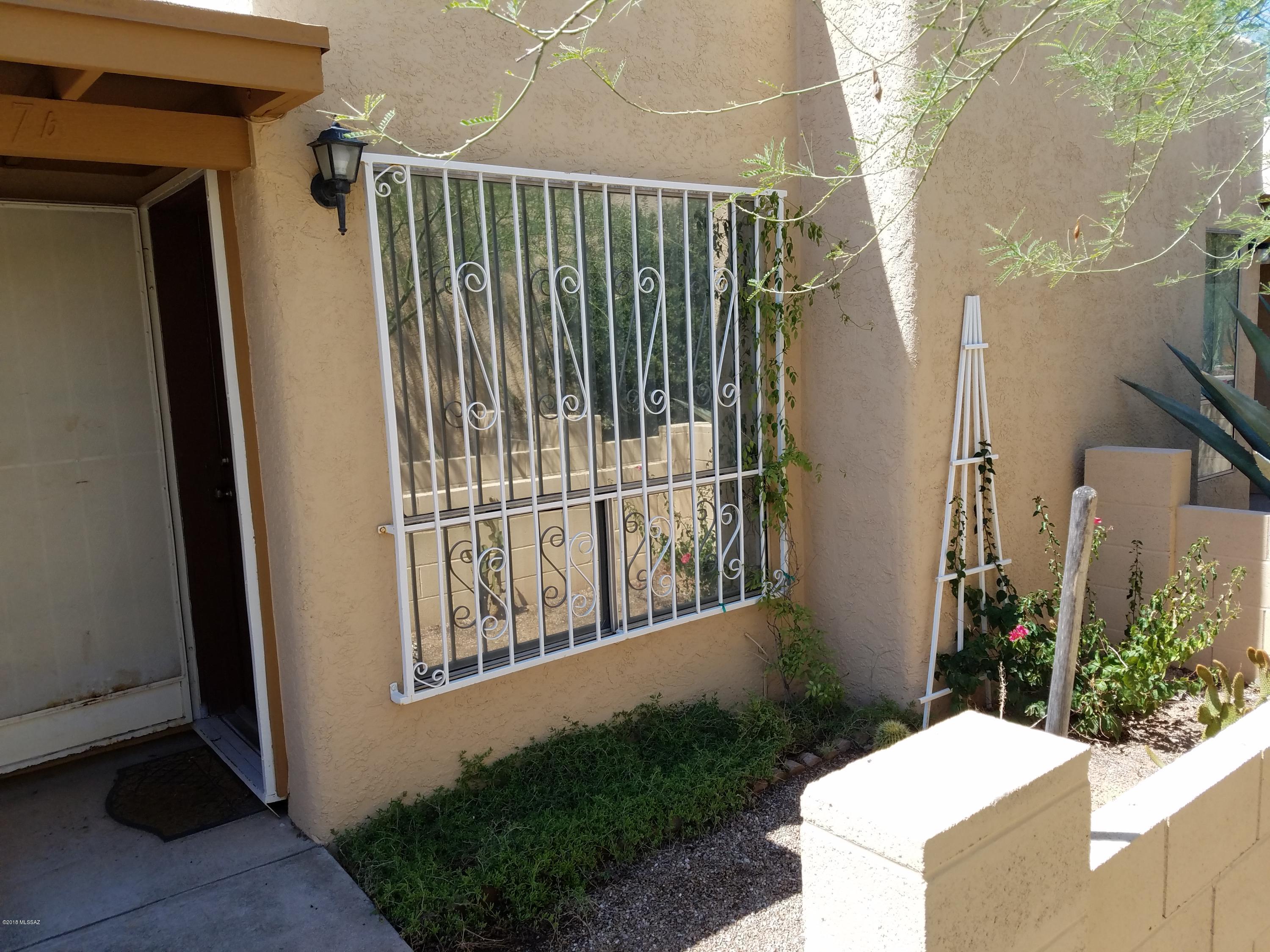 Condo with large fenced yard with front & back patios. Drip irrigation on timers.