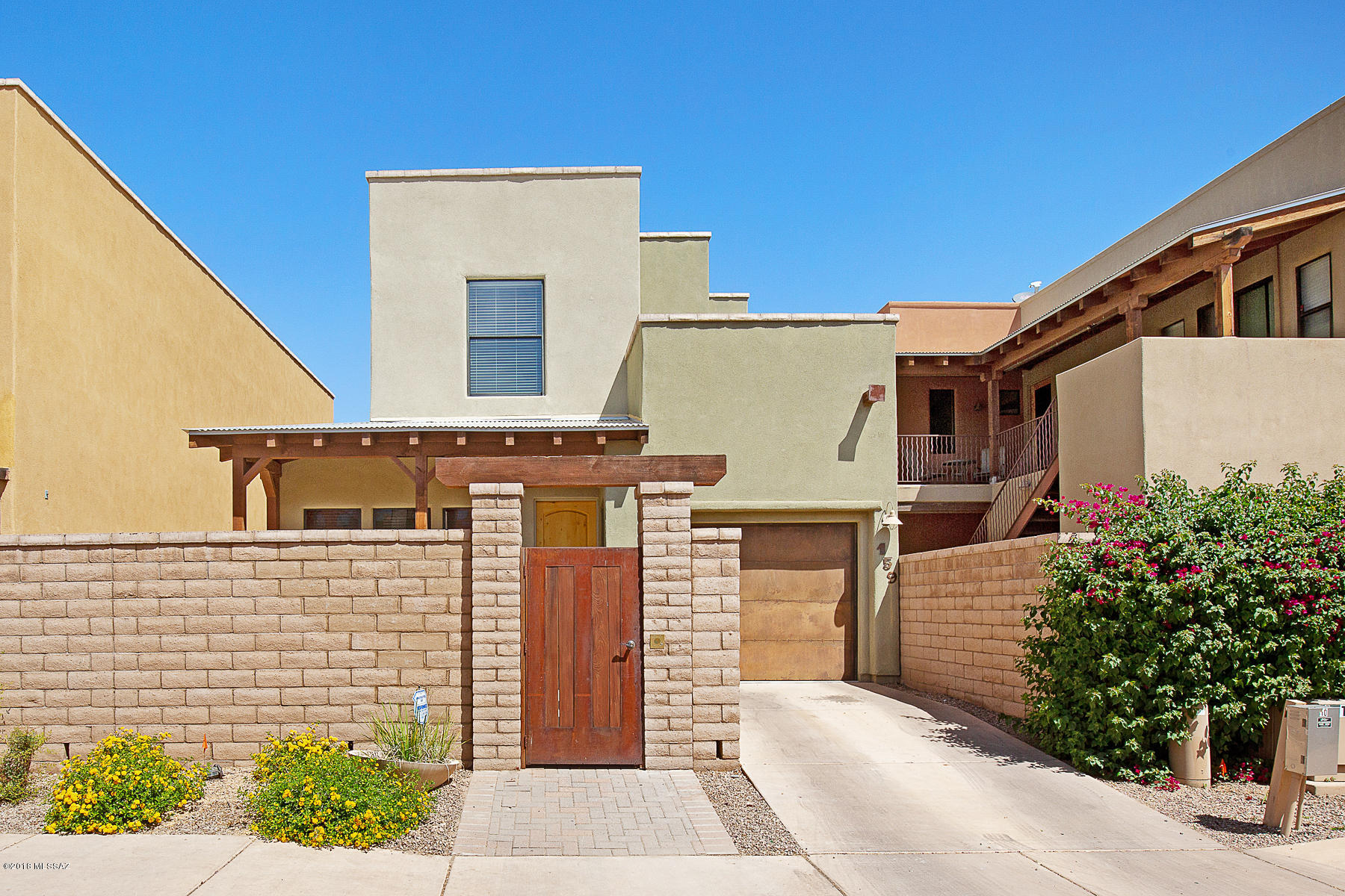 Outstanding urban living home in the upscale gated Miramonte at the River featuring the Barrio style architecture. This greatroom concept is anchored downstairs by the spacious open kitchen with rich granite tile counter and stunning 42' hickory cabinets/crown molding, modern island with breakfast bar, walk-in pantry, greatroom open to the the light w/high ceilings. Sophisticated dacor of 'new-model home' interior, freshly painted designer colors, brand new carpeting, fine tile floors and wrought iron railing. Side yard hosts the garden paver patio for dining and BBQ wraps around to charming front courtyard entry. Master Suite bath hosts cultured granite counters and shower, large walk-in closets. Convenient laundry upstairs with builtin cabinetry.