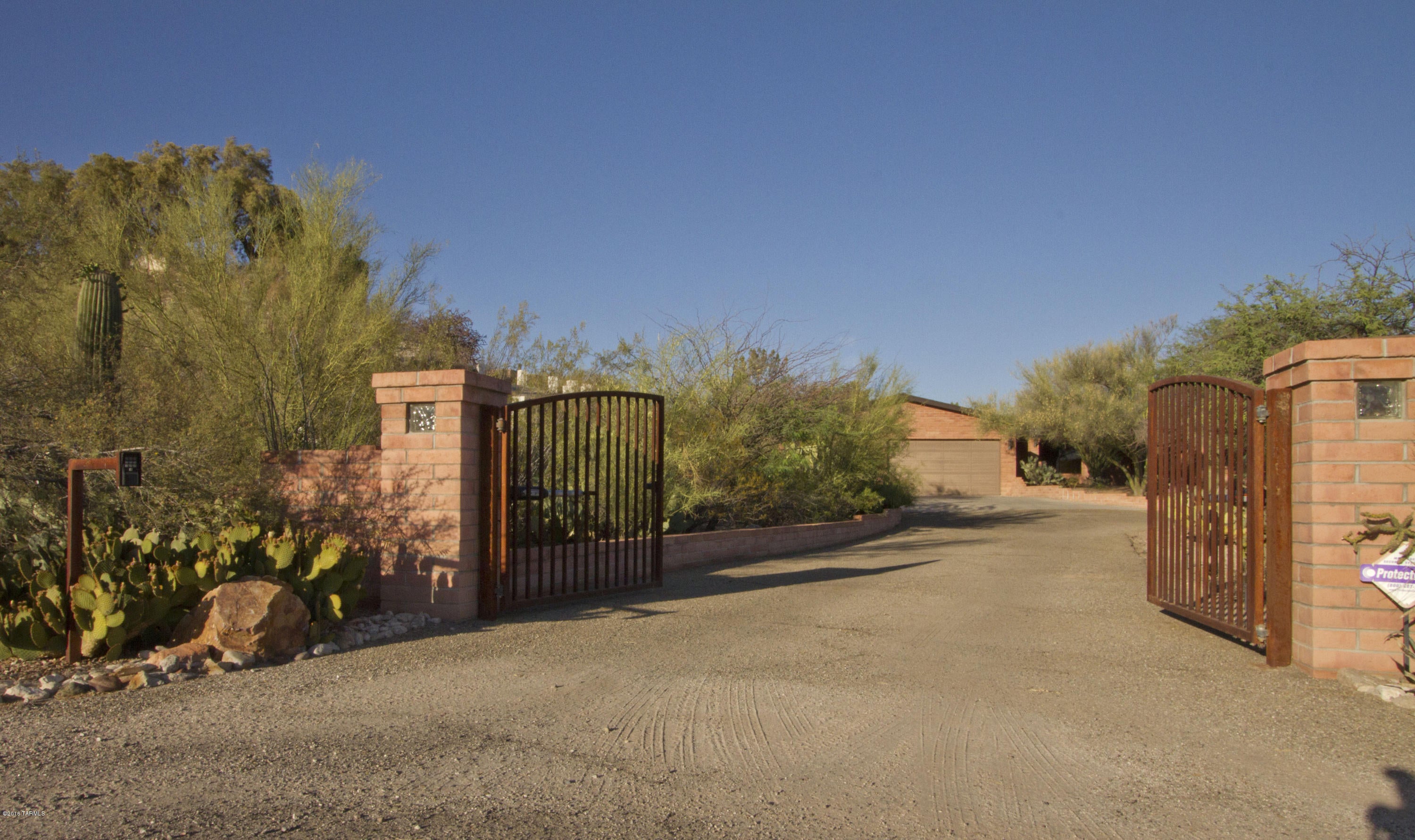 Gorgeous custom quality built home. 4 bed, 4 bath, ranch beauty with amazing views of the city, mountains and sunsets. Centrally located north of River Road in the Catalina Foothills, this privately gated home offers views, outdoor living, huge extended 3 car garage wired for a workshop, upgraded kitchen with granite counters, guest quarters with attached 3/4 bath and plenty of space for a large family. Quiet neighborhood with Tucson Mall shopping and the U of A just minutes away.