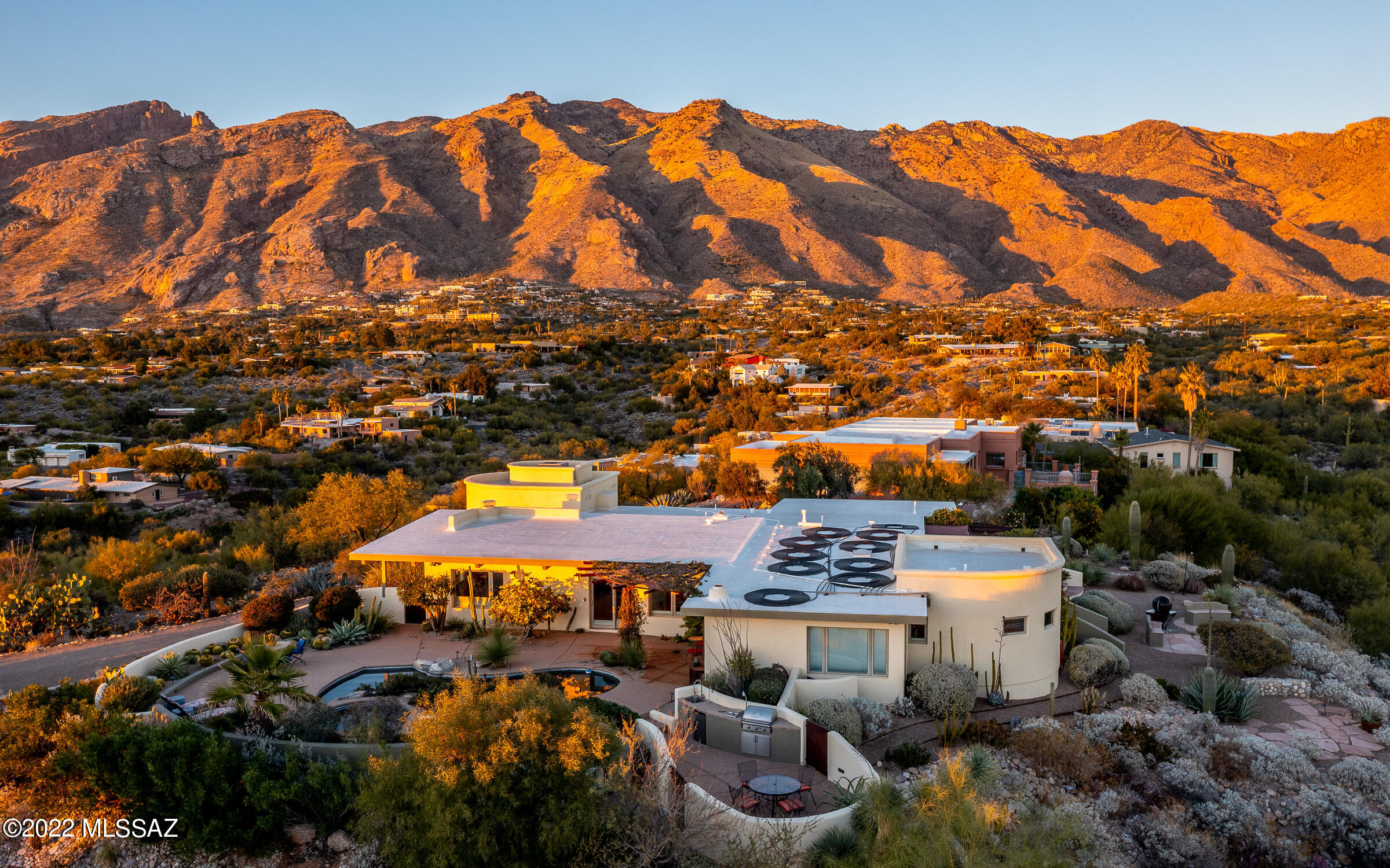 Enjoy resort style living in this gracious, totally remodeled home with award-winning landscaped grounds. Situated atop a ridge, the home provides breathtaking panoramas of sunrises, sunsets, city lights and all four mountain ranges. The home features two living areas, one with a cozy stone fireplace and the other with jaw-dropping views.
Granite counters, maple cabinets, Viking, Wolfe, Sub-Zero and Bosch define the large chef's kitchen. Multiple outdoor living and dining areas and a well-equipped outdoor kitchen are convenient to pool, spa, kitchen & bedroom. The generous Owner's Suite w/ fireplace has city & mountain views, access to pool deck & two ramadas, luxury bath with large walk-in shower.
HOA includes a half-Olympic-size community pool and two tennis courts.