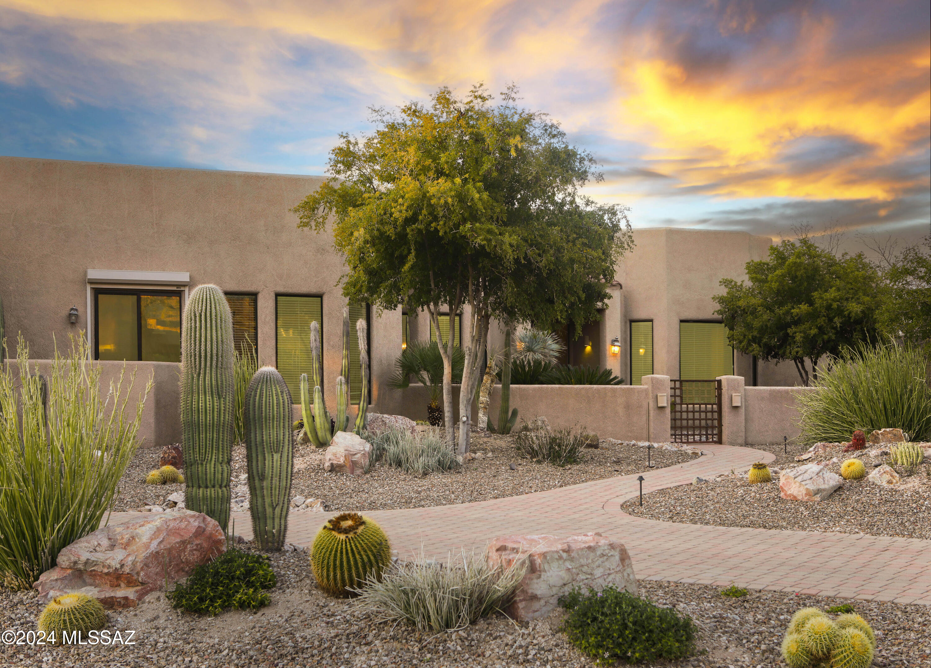 Marvelous Pusch Ridge vistas grace this 2007 custom-built home is nestled in the prestigious 3rd Fairway of the Oro Valley CC neighborhood. The gated courtyard warmly welcomes you into this 3,147 SF split floor plan residence. Upon entry, the foyer leads to elegant Formal Living and Dining areas, ideal for hosting guests. The well-appointed kitchen is a culinary haven, boasting exquisite alder cabinetry, 
granite countertops, and a substantial center island. Noteworthy Dacor appliances incl. a 6-burner gas cooktop, microwave, dishwasher, double ovens, & KitchenAid built-in refrigerator. Enjoy the well-organized oversized pantry with ample shelves & wire baskets. The Butler pantry showcases custom alder cabinetry, a sink, & two beverage coolers.  (continued) The cozy family room features yet another fireplace and a private covered patio.  The tranquil Primary Suite has a gas fireplace, bay window, and an opulent bath complete with a jetted tub, walk-in shower, and an amazing custom-designed walk-in closet featuring generous shelving, storage, drawers, and more. Two comfortably sized guest rooms offer walk-in closets and share a jack-n-jill bath. A separate office boasts custom built-in desk and cabinets.  Nearly every window provides breathtaking views of the Catalina and Tortolita Mountains. 

Outdoor living is enhanced by an expansive covered patio overlooking a professionally landscaped backyard. Dog enthusiasts will appreciate the well-built dog run with access from the office. Additional features include an oversized 1,039-square-foot three-car garage with a spacious storage room and high ceilings. The laundry room offers a washer & dryer, separate sink, upper & lower cabinets, and plenty of counter space.

Enjoy the country club living whether it's a round of golf, pickleball, a relaxing walk around the community, a bike ride on the popular 131-mile multi-use "Loop", or the convenience to dining and shopping.  Make this home yours today!