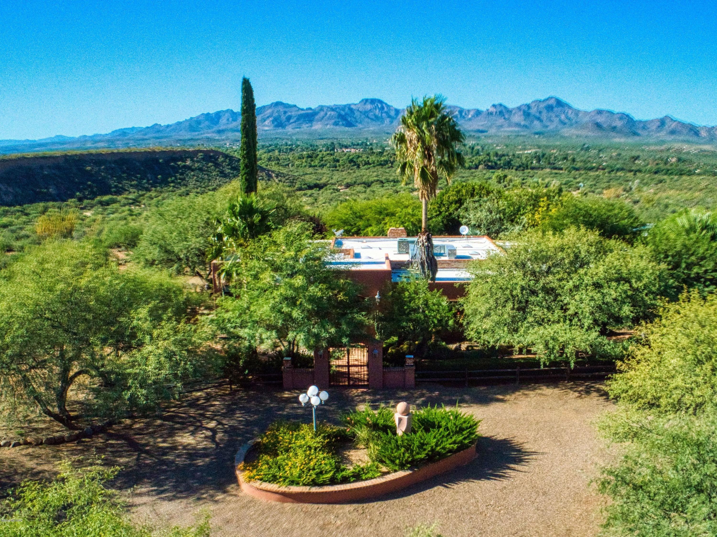 Outstanding views in every direction combined with elegance and function describe this 3998 square foot 3 BR/3Ba estate situated on a 10 acre bluff overlooking the entire Santa Cruz Valley! Extensively remodeled, this breathtaking home has everything you would expect including lush grounds with pool and spa nestled  among mature mesquite trees; a ramada looking down toward the Santa Cruz River Valley with the Tumacacori Mountains as a backdrop! The homesite has a masonry wall entry with wrought iron gates and a circular driveway with plenty of room for guest parking. Once inside you will enter through an elegant foyer to find a large family room with plenty of windows looking out to the enclosed backyard and patio area as well as porcelain tile floors and a wood burning fireplace for those chilly desert nights.  The kitchen was meticulously professionally designed and is complete in every respect including lots of counter space and storage, yet all of the appliances you need are close at hand. The large master bedroom is warm and inviting and has a comfortable sitting area as well as a large master bath with soaking tub and separate shower.   This home exudes the Tubac lifestyle!  Make an appointment for your most discriminating clients."