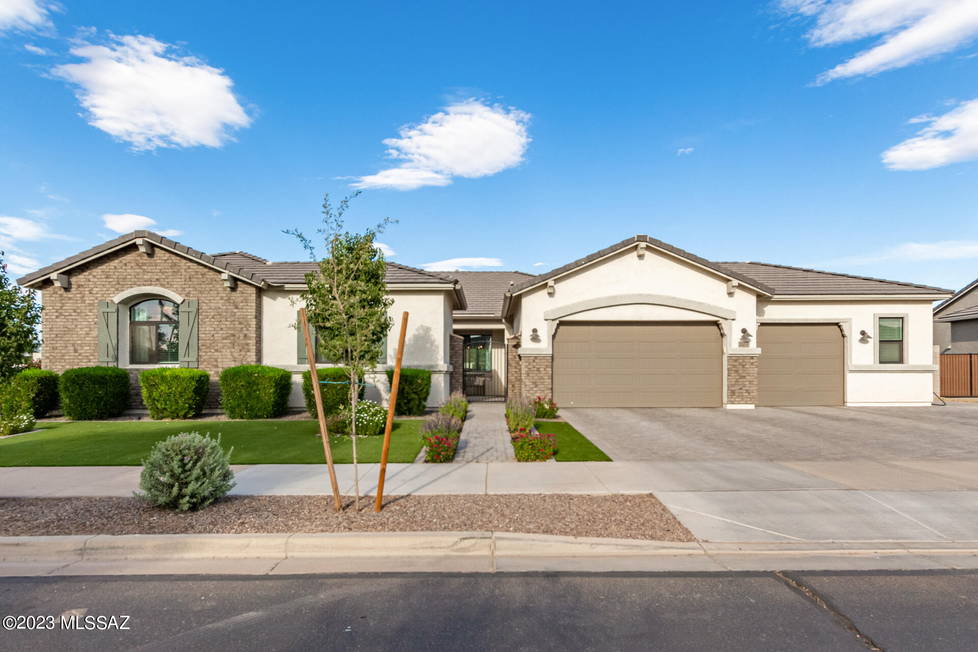 Entertainers Delight! The sellers of this 2-year New Semi-Custom Stunning Home spared no expense when building & designing it, starting with European Solid Oak floors throughout the home.  From the front gated courtyard, enter home w/ impressive 10' ceilings and an open floor plan that will WOW you. With 5 bedrooms plus a flex room and 3 full bathrooms, this floorplan meets the needs of most any family. 4 of the bedrooms have walk in closets and all have high end Berber style carpet. The large gourmet kitchen w/eat in nook boasts an oversized island, granite counters, gas cooktop, and abundant cabinets with a huge walk-in pantry. The great room has adjacent formal dining room, and double atrium sliding doors to the Oasis backyard featuring a Sparkling pool w/ water feature, SEE MORE HERE a 12'X14' Gazebo which is gas and electric ready, and beautiful high quality synthetic grass. You can fit 3 large vehicles with room to spare in the extended width garage w/epoxy floors & built in cabinets as well as a rear garage door with opener.  The 10' RV gates lead to a large slab in back for parking your RV on property. Front of the home has extended pavers for plenty of guest parking, lush landscape w/synthetic turf for easy maintenance and no mowing for green grass year-round! There is so much this home has to offer, the list goes on; Imported stand-alone soaker tub and oversized walk-in shower in primary bathroom, soft close cabinets throughout, upgraded lighting fixtures, double wall ovens, solar lights around back wall, extra concrete pad in back for additional patio set or fireplace. Come see your new Dream Home today!