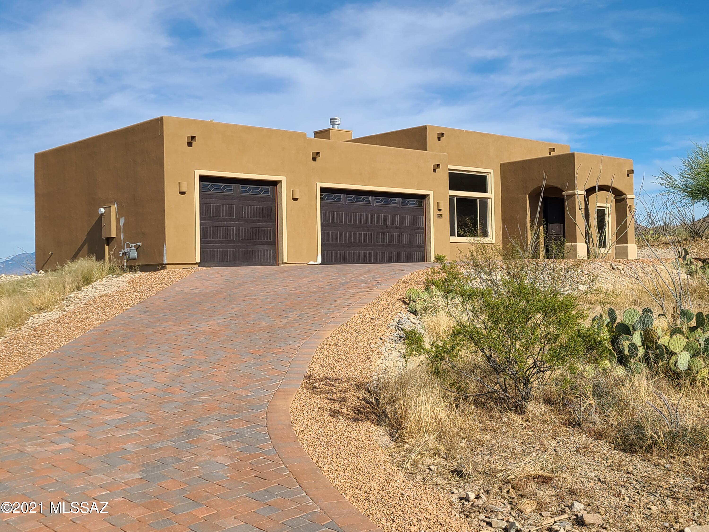 Gorgeous new home on an private 4.1 acre lot nestled in the foothills of the Santa Rita mountains with spectacular views in every direction! 4 bedrooms & 2 1/2 baths with a separate den/media room. Huge master bedroom with bay window that overlooks the valley. Gourmet kitchen with 36'' gas cooktop, double oven/microwave, big pantry, generous cabinet storage & large island with additional cabinets below. Beautiful paver brick driveway leads to an oversized 3 car garage that any man would love. Block wall around back yard will be completed before close of escrow. This one won't likely last long, show it right away!