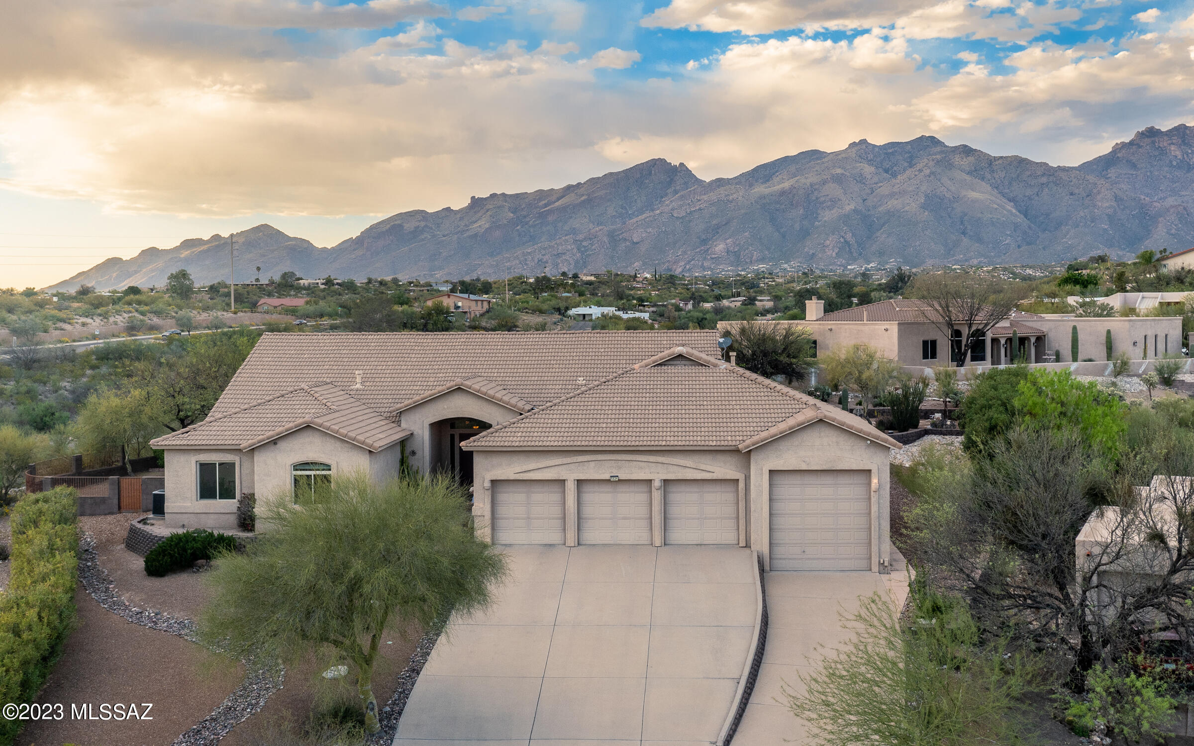 Sophisticated split 4BR/3Bath floorplan, 3229sqft, 4Car Garage, located in the Rio Verde Vista community. Entry foyer sets the tone, w/Egyptian Ceramic Tile, Formal Living & Dining room, Spacious Kitchen, FP, Family room & high ceilings.  The floor plan comprises both formal & informal living spaces, equally suited for entertaining, as well as quiet moments. Kitchen boasts a large center island, custom cabinetry, ample storage, granite counters, corner desk, dining nook, & serving hutch. The primary suite features a spa-like bathroom, spacious walk-in closets, jetted tub, dual vanity separate shower & bidet. West wing has 3 BRs, custom hall cabinet,  full bath with dual vanity perfect for guests or family & powder room. Professionally landscaped backyard has elevated Hot Tub, Fire pit, West yard has a children's wood play set. The Outdoor living spaces are accessed from the Primary Bedroom Suite and Family room. 
Built  in 1994, 3,229 sq. ft. located on a hill in a cul-de-sac by near Craycroft & River Road. Home has Catalina Mountain views & City lights. This 4-bedroom, 3-bath home features an open floor plan with a family/great room, a formal living room, large kitchen, dining nook, formal dining room, and wide, gallery hallways. There is plenty of space in the 4-car garage; one garage could be used for a full-size RV. Block Construction w/8"Stucco exterior Steel interior framing, and insulated walls & ceiling. Home originally built for the builder's family with this family to be the second owners. Home plans will convey.