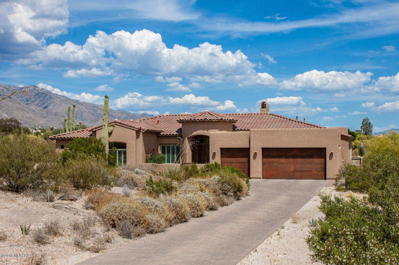 Beautiful A.F. Sterling custom home built in 2015
located in Catalina Foothills Estates.  Lot feels very private with mountain and city views.  Home is located minutes from restaurants and shopping. 
Many custom features include wrought iron courtyard gate ,rustic garage doors, floor to ceiling brick fireplace , plantation shutters, chefs kitchen
with quartz counters that opens to the family room.
Master suite w an oversized double shower w/rain
showerhead , soaking tub and double vanities.
Enjoy the extended patio for entertaining , resort style backyard with pool/spa and artificial turf. Unobstructed mountain views.