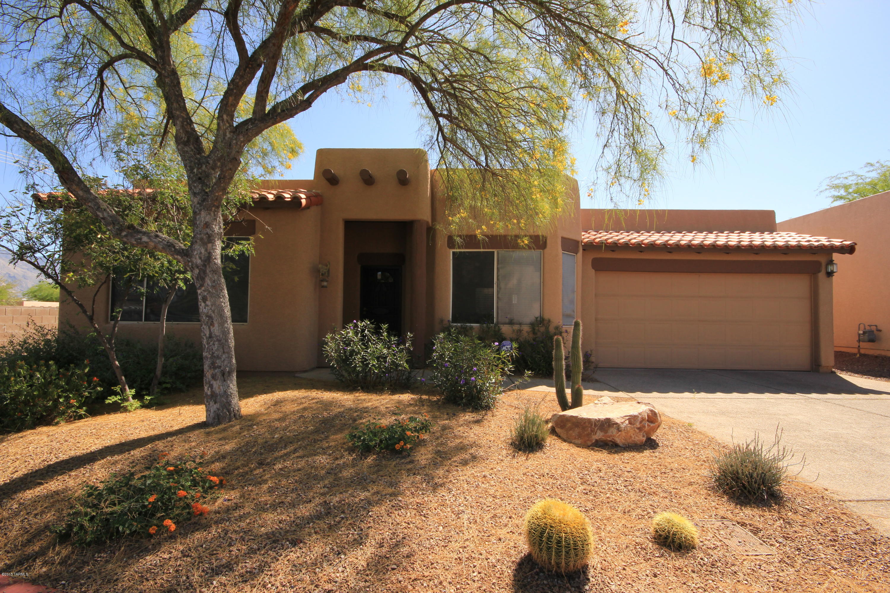 Fantastic location at the end of the subdivision offers beautiful mountain views and privacy. This charming Crest Ranch Home features scored concrete floors throughout and carpet in bedrooms, formal living and dining, open kitchen family room area with fireplace, breakfast nook, kitchen island, roll out shelves and pantry. French doors from Family Room or Master Suite lead to covered patio with pretty low care landscaping and Catalina Mountain views. Ceiling Fans throughout all rooms, Modern High ceilings, wood blinds, skylights, coat and linen closets. All bedrooms feature walk in closets. Master has mountain views, jetted tub, separate shower, dual vanities. Third bedroom has double doors from entry and could be a den. Washer, Dryer, Refrigerator and built in Microwave are included
