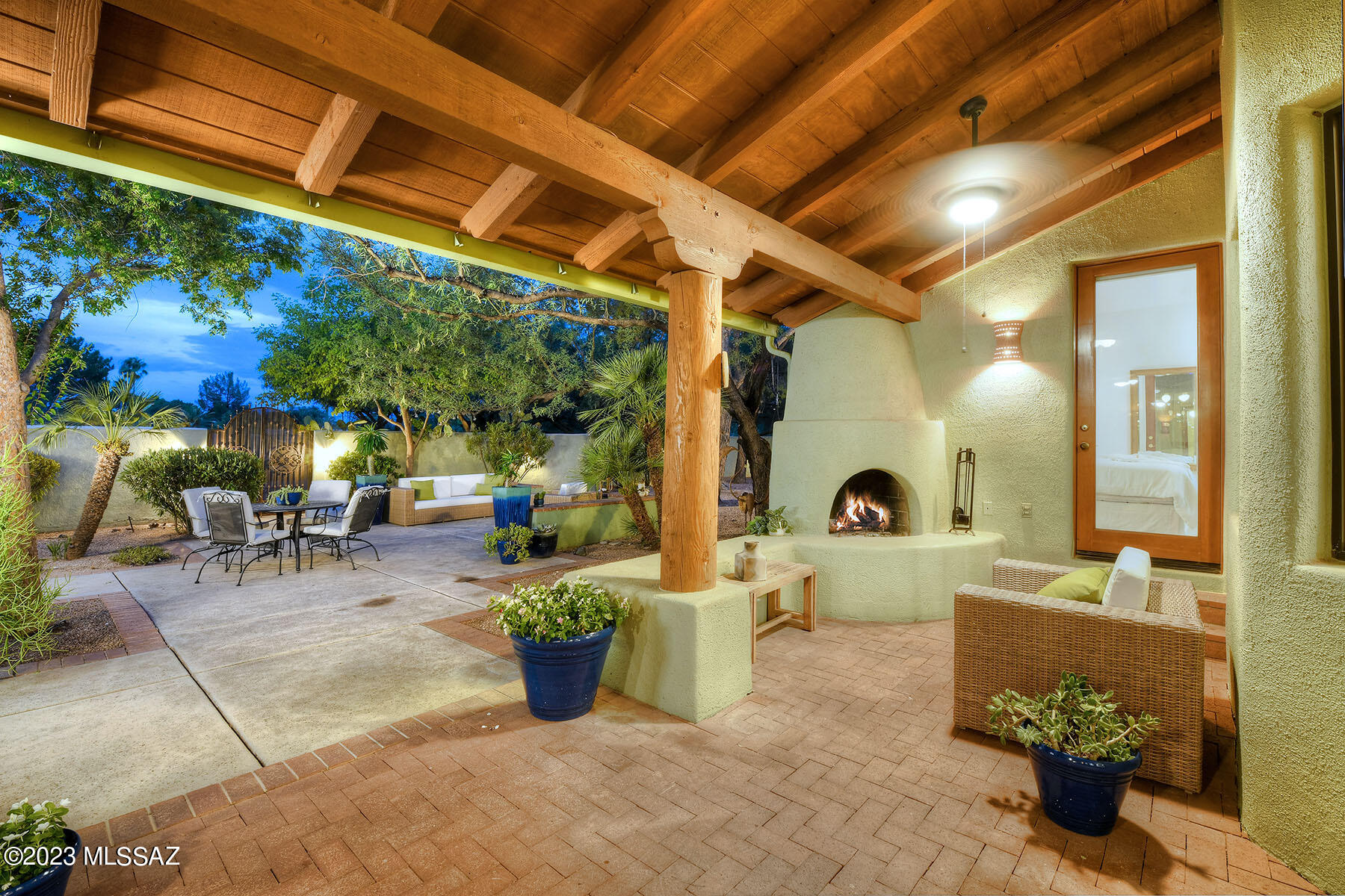 Inviting...  that is truly the word to describe this home. A touch of Mexico, yet totally adaptable to any style.   High ceilings with vega beams, Saltillo floors accented with Talavera tiles, and just an overall open feel.  Split bedroom plan with both the master and one other having doors to the outside .  
The back yard living is lush and welcoming.  Picture brick patios, a plunge pool/spa that is ever so tranquil, and a small amount of grass.  Custom iron gates lead to a second yard that abuts the golf course.  If you don't know 49ers you need to.  A true community of winding streets, big trees, and a pool/community center that is fabulous.  
Don't miss...  anything in this neighborhood always sells so quickly
