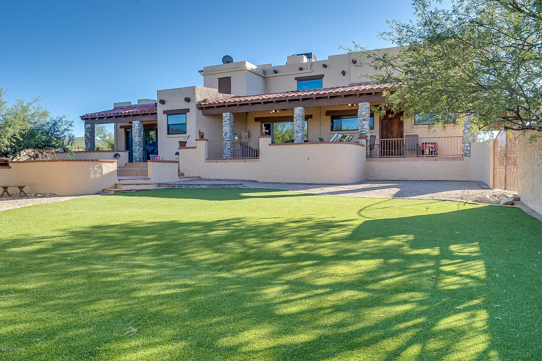 Picturesque 30 AC registered ranch at base of Rincon Mtns. Breathtaking 360 degree views on saguaro studded acreage w/seasonal waterfall & sandy washes for riding, walking & enjoying nature. Sunrise, sunsets, dark skies & total privacy. Inviting & comfortable  well-maintained home, newer roof, HVAC & windows. Dramatic floor to ceiling stone FP, versatile floorplan w/separate dining, living, family rooms, den &  small, charming, loft office. Spacious master retreat, FP, & lots of windows. Kitchen overlooks lrg walled-in backyard, patios & pristine no care turf. Horse facilities incl 7 stall barn w/4 turnouts & covered turnout at end, tack rm, storage, full size lighted roping arena, round pen, turnouts, corrals, RV hookup, trailer parking. Endless riding trails. Vail Schools. Very special