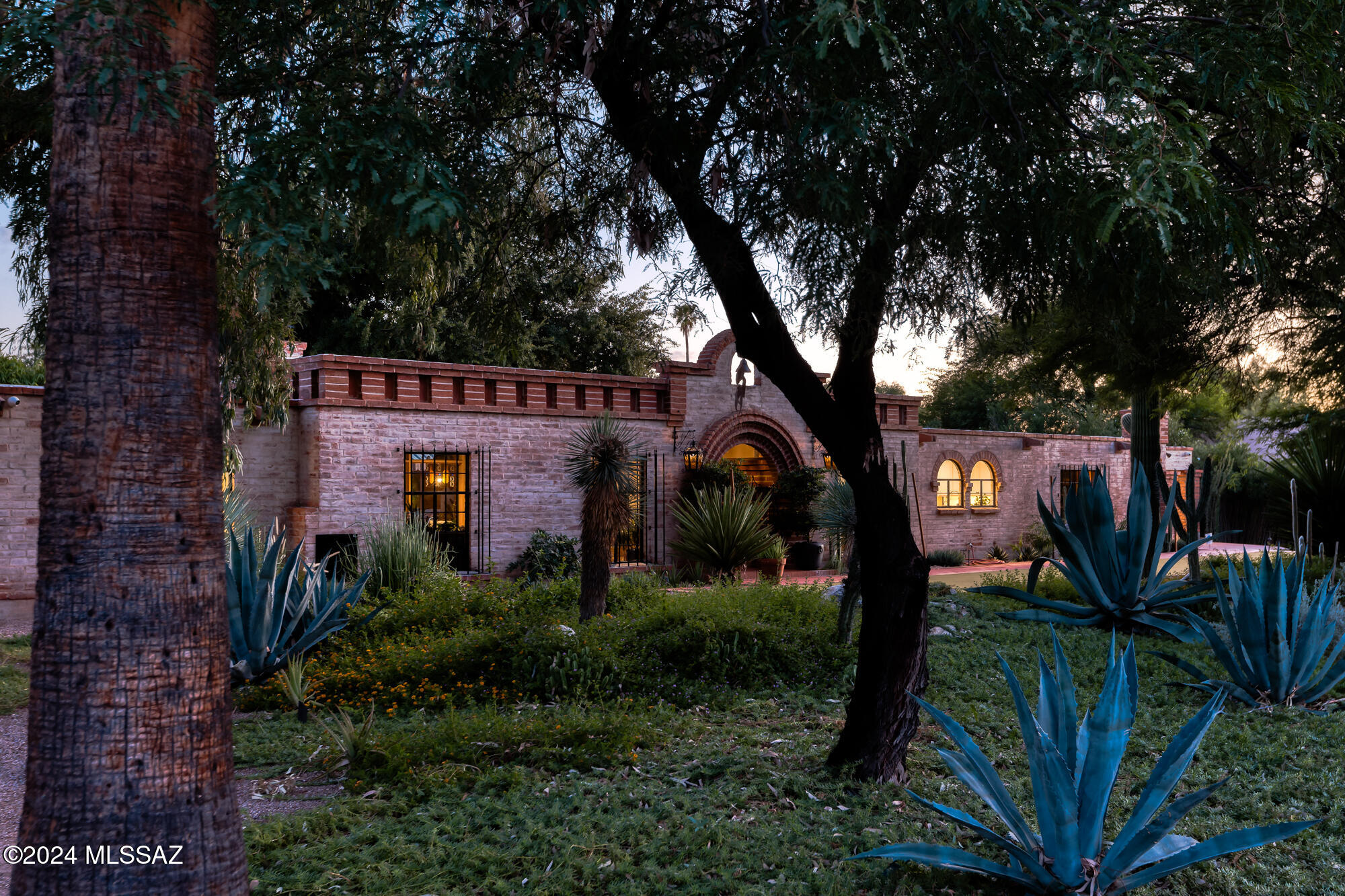 Stunning Territorial-Style Burnt Adobe Home in Historic El Encanto Estates. Designed by Lewis Hall, an apprentice of the renowned Josias Joesler, this home is a seamless blend of historic charm and modern comfort. This exquisite over 3700 sq ft, 4-bedroom (plus a den with ensuite bath that may serve as a 5th bedroom), 4-bath home is a true gem in the heart of El Encanto Estates. Step into an oasis of tranquility with mature trees and lush vegetation surrounding the property, creating a private, quiet retreat. The tasteful backyard features a large, heated pool, synthetic turf, and ample shade provided by beautiful, large trees. Enjoy seamless indoor-outdoor living with a wall of glass that opens from the living areas to the backyard, bringing natural beauty into your everyday..continued