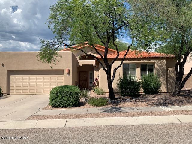 Beautiful 3 bed split floor plan plus large den with a north facing back yard. Newer custom built kitchen with SS appliances and lots of cabinets for storage, opens to a gorgeous family room with custom fireplace. This home offers two separate large living spaces, a dining area and breakfast bar. Move in ready and plenty of room for family and friends. An easy care back yard with lots of shade and view of the Catalinas allows endless fun and relaxing. HOA takes care of the front yard.