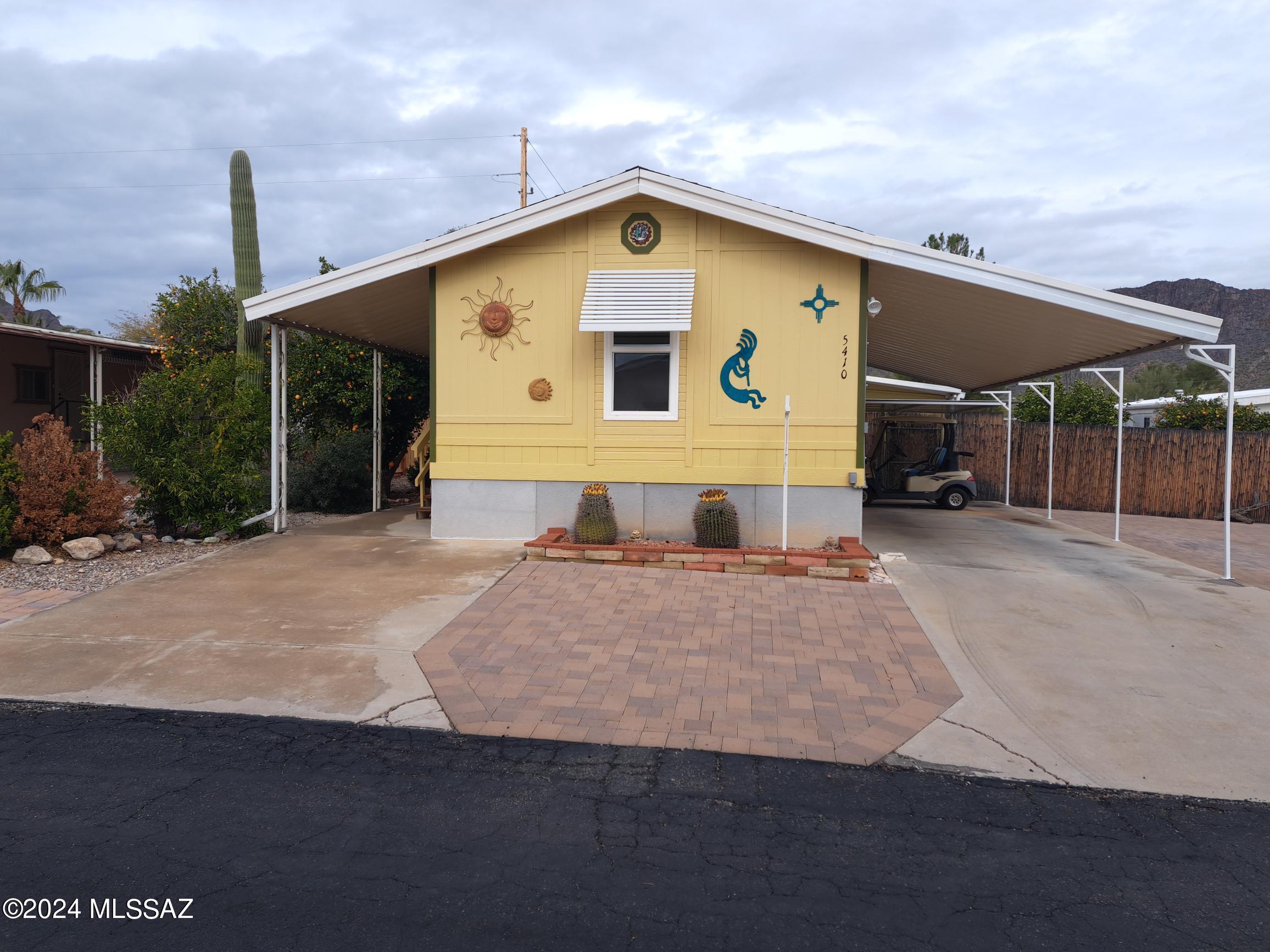 Excellent winter home or year-round living in 55+ community.  Split-bedroom floorplan with new dual-pane windows throughout.  Lovely bay window in the kitchen to enjoy your morning coffee. Great covered patio with views of the Tucson Mountains and is perfect for entertaining.  Beautiful pavers around the front and east side of the home.  The fenced in yard is great for your dog and some additional privacy.  Storage shed and additional workshop/storage.   
 Furnished and is move-in ready! ** Please see the upgrade list in the document section.**