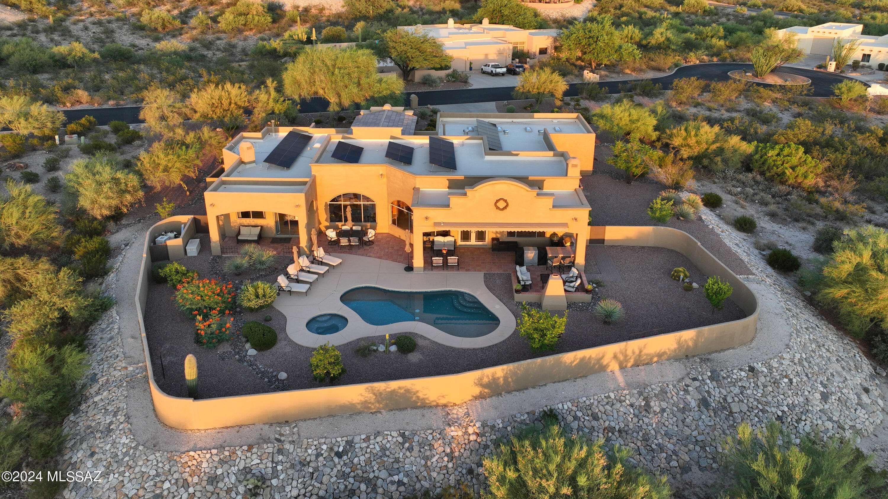 Beautiful move-in ready home in the gated Green Ridge community with incredible Catalina Mountain views from inside and out. The home has 2897 sqft with 4 BR/3 BA split bedroom plan. New tile throughout the home, high ceilings with wood beams in the main living areas. Chef's kitchen features Quartzite counters and backsplash, stainless steel appliances, and breakfast bar. Family room with fireplace, formal living & dining with niches & built-ins for added charm. Large primary with double-sided fireplace, separate tub and walk in shower. Out back you will be greeted by the pool and spa with all new pebble-tec, mountain views, outdoor kitchen, & a fireplace. The owned solar is an added bonus! Don't miss your chance to own this home in the Tanque Verde Valley.