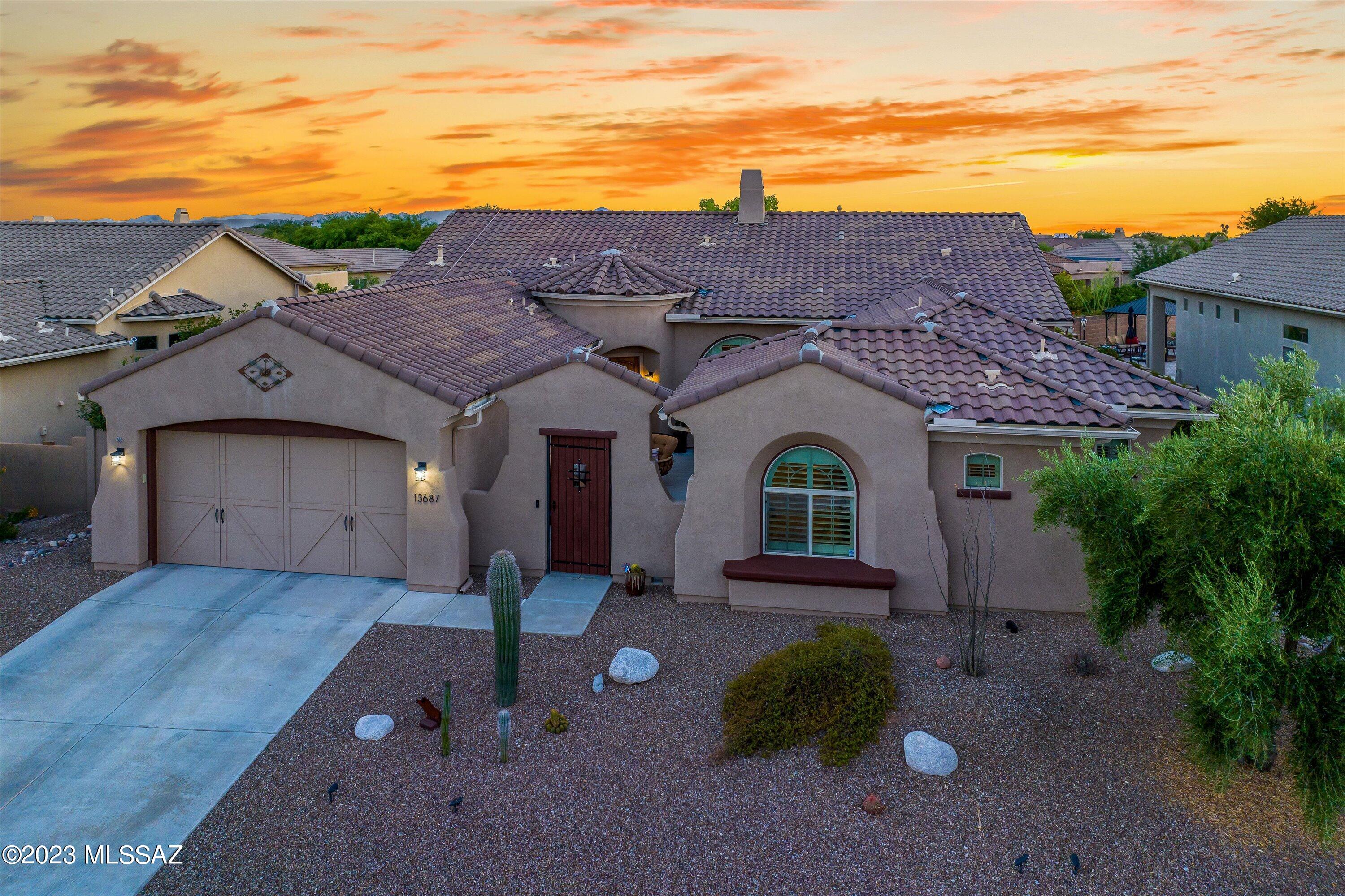 Stunning contemporary home in Oro Valley's gated enclave of Siena at Rancho Vistoso.  This 4 BD/3 ½ BA/3,076 Sq.Ft home offers high ceilings, plantation shutters throughout, owned solar system for low utility bills & spacious bedrooms. Floorplan features a great room concept family room, separate living area, formal dining & powder bath. Chef's kitchen has a large island w/seating, granite counters, tile backsplash, stainless steel appliance w/5 burner cooktop & built-in refrigerator, closet pantry, under cabinet lighting & tons of cabinet space. Spacious primary bedroom suite w/custom tiled shower w/2 shower heads, separate soaking tub, split vanities & his/hers closets. Jack & Jill baths for 2 guest bedrooms & private en-suite bath for 4th guest bedroom. Backyard has an extended..... ......covered patio, pebble tec pool & raised spa, outdoor kitchen/BBQ, artificial turf, fruit tree grove & mature landscaping. Front gated courtyard is perfect for entertaining. 3 car tandem garage.