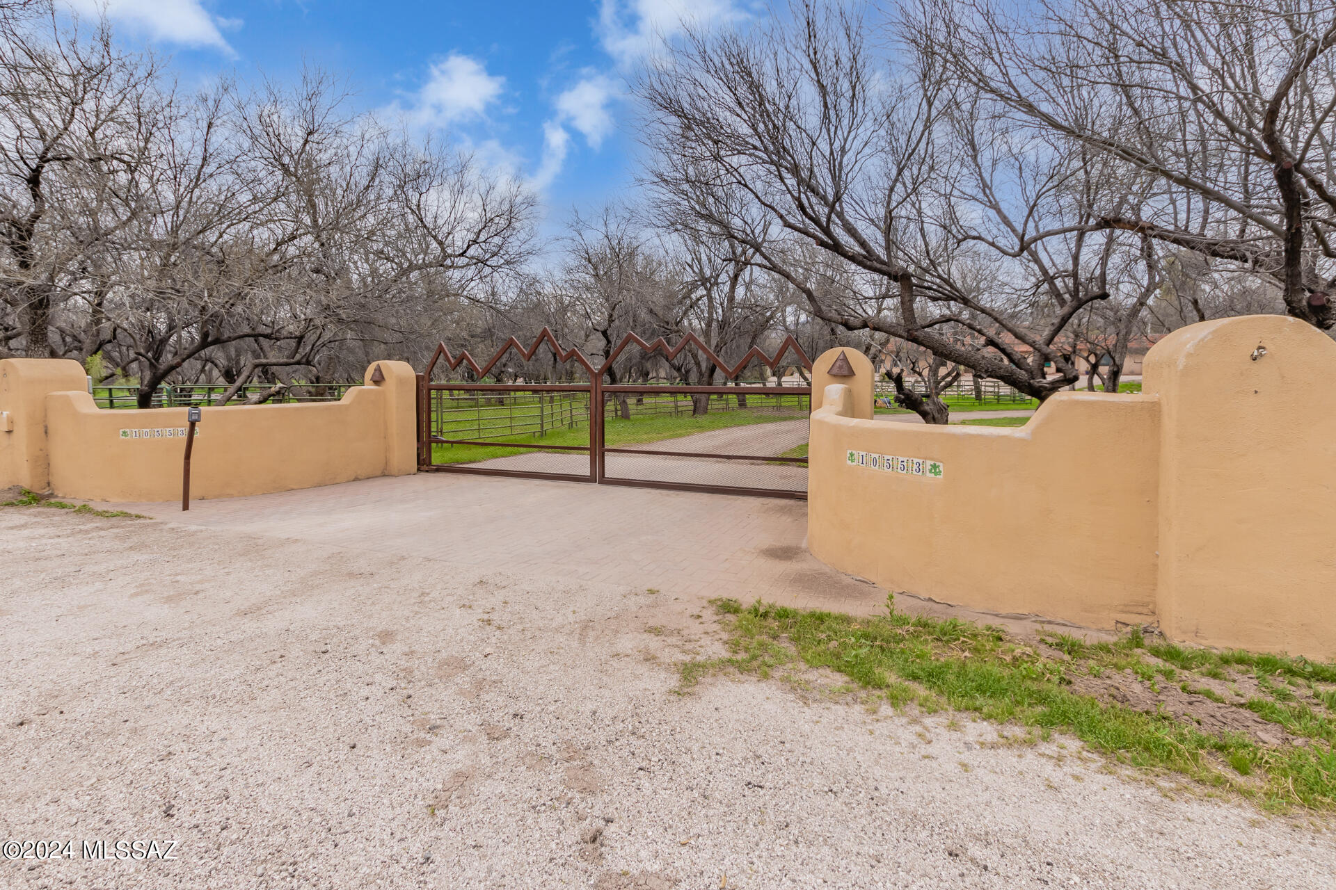 Welcome home! This horse property is nestled on a picturesque mesquite grove 1.39-acre lot, The entrance is inviting, with a cozy front porch that sets the tone for the warmth and charm within. Inside, the home exudes rustic elegance, featuring a blend of carpet and tile flooring that adds both comfort and style. The ceilings are adorned with beautiful wood paneling, enhancing the home's cozy, cabin-like feel. The living spaces are designed for relaxation and entertainment, with fireplaces in both the living room and family room, creating inviting areas for gatherings or quiet evenings. With 2 primary suites flooded with natural light. Outside, a sparkling pool awaits, surrounded by lush landscaping and ample space for lounging and soaking up the Arizona sun. Schedule your showing today! The formal dining area is perfect for hosting gourmet meals, while the kitchen is a chef's delight, showcasing rich wood cabinetry, tile counters, and stainless steel appliances. A quaint breakfast nook provides a charming space for casual dining. The main bedroom is a spacious retreat, complete with a corner fireplace for added ambiance. It offers direct access to the backyard, ensuring a seamless connection with the outdoors. The room also boasts an ensuite and a walk-in closet, providing ample space for comfort and organization. A large loft area overlooks the main living space, offering versatility as an office, media center, or additional living area. This space adds an extra dimension to the home, catering to various needs and preferences. The backyard is an expansive and tranquil oasis, perfect for relaxation and entertainment. It features a covered patio for al fresco dining or lounging, an exterior fireplace for cozy evenings under the stars, and seating areas for hosting guests. The refreshing pool is the centerpiece, promising endless fun and relaxation during warmer months. Additionally, the property includes convenient vehicle entry, a sizeable shed for extra storage, and ample space for creative landscaping ideas. This horse property is a unique gem that combines rustic charm with modern amenities, set against a backdrop of stunning natural beauty. It's a must-see for anyone seeking a tranquil, picturesque lifestyle with all the comforts of a well-appointed home. Don't miss the opportunity to make it yours!