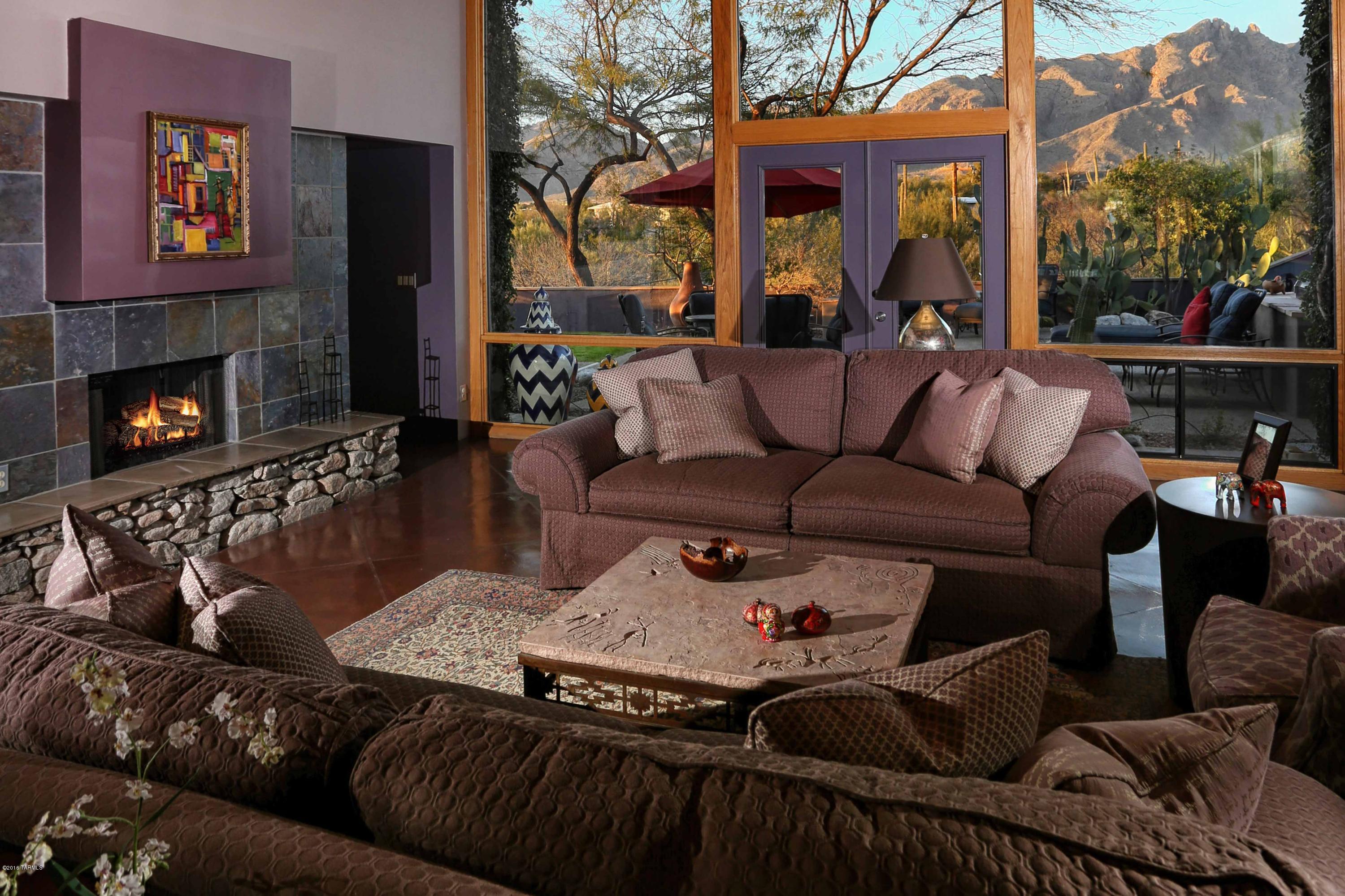 A stunning Southwest contemporary designed by Architect David Tyson. This hill top property has soaring floor to ceiling windows which capture amazing views of the Catalina Mountains. Located in Catalina Foothills District #16, Manzanita Elementary. The main house has 4 bedrooms and 3 bathrooms with an attached guest house/office that offers an additional 2 bedrooms/ 1 bath. This home has a flexible floor plan that showcases the vibrant use of color. Outdoor oasis with a oversized spa/''spool''.