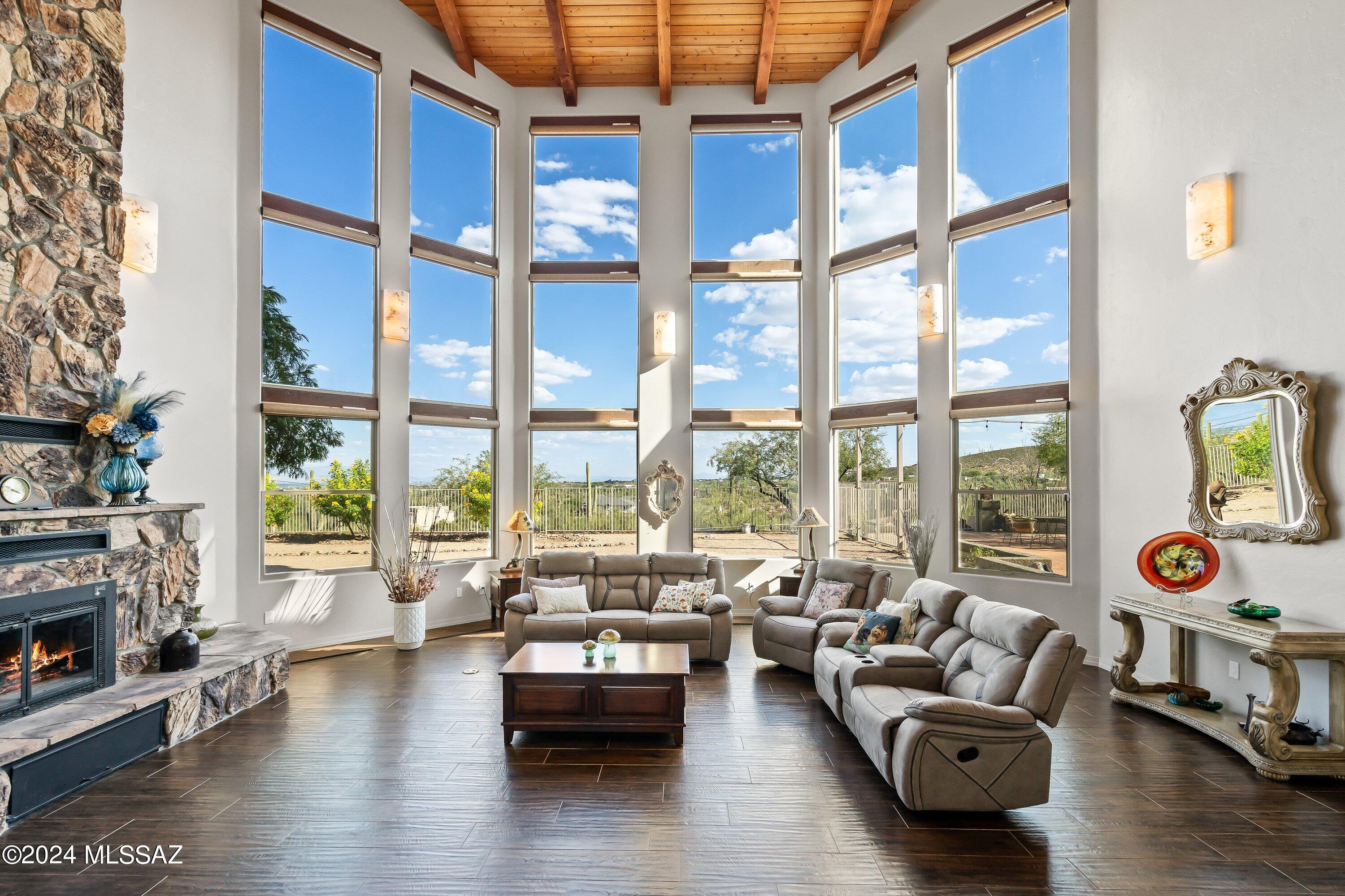 Welcome to this exceptional property that offers over 5 acres of premium  land, perfect for your equestrian dreams or private oasis. The barn features stalls, a tack room  and plenty of room for hay storage. Enjoy riding and hiking trails footsteps from your front door. This is truly outdoor living at its best! Relax and entertain on your private patios or multiple decks, surrounded by lush landscaping and breathtaking panoramic views. Step inside to find a  a masterpiece of modern accents combined with old world design, featuring stunning floor-to-ceiling windows that offer breathtaking views that flood the interior with natural light.  The heart of the home is the gourmet kitchen that is a chef's dream.  Equipped with top-of-the-line appliances and sleek cabinetry and a walk in pantry. Take a look at the special features list to get a true sense of the value this home has to offer. Start your new year by moving into this  one of a kind home that can offer a new family many opportunities to grow for years to come. Close to the U of A, shopping, schools and downtown Tucson.
