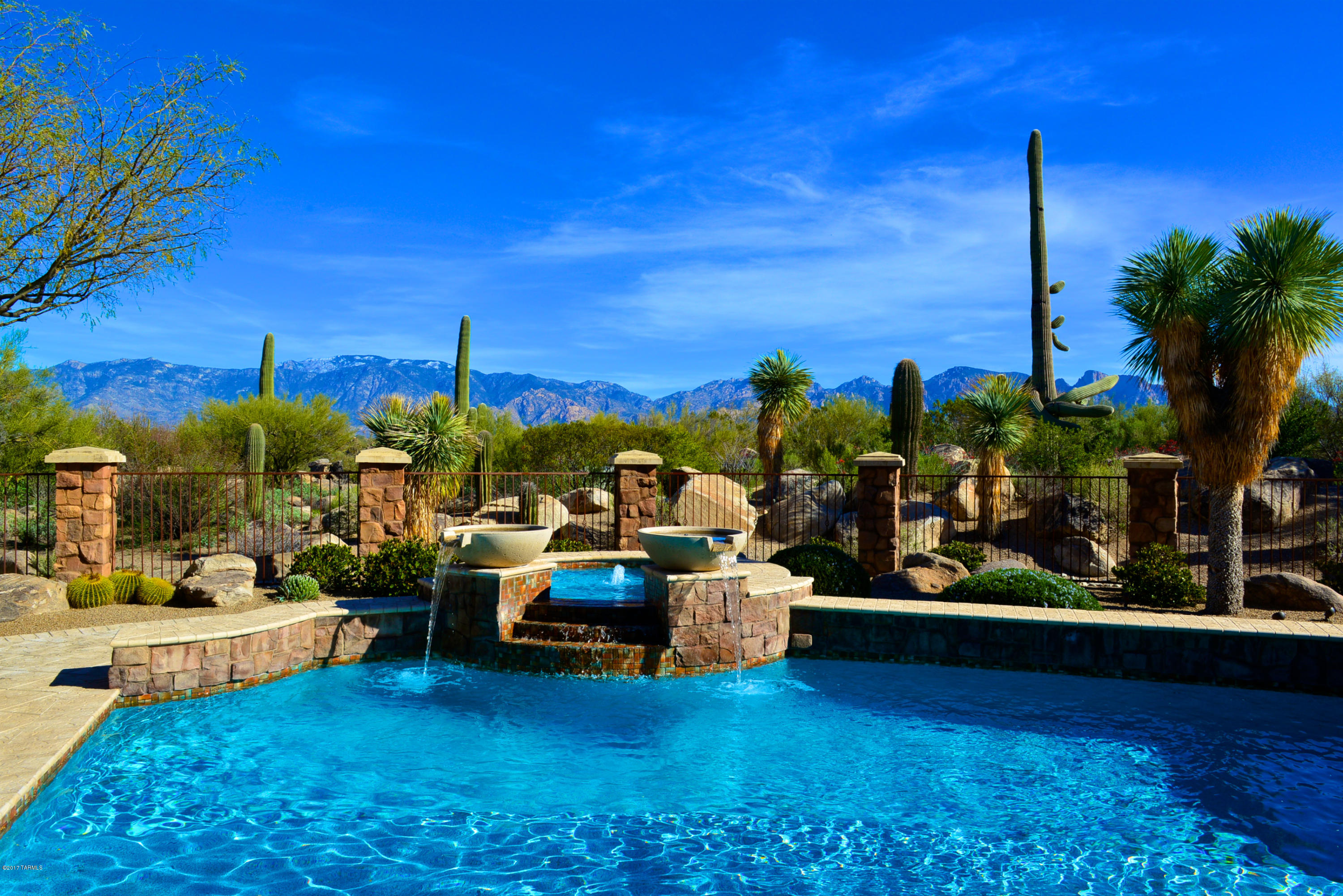 Serene panoramic Catalina Mtn views and Old World charm with luxury amenities create an inviting, comfortable retreat! Great room with high ceilings, beams and Cantera Fpl leads thru wall of folding French doors to relaxation-oriented patio with pool/spa, 2 Fpls & cov'd BBQ. Regal materials (marble, granite, pewter, travertine, hardwood & Cantera) enhance the feeling of quality. Features: 3BR, 4BA, Office, Exercise/Sitting Rm, 2 Laundry Rms, separate Guest Wing, wetbar with floating seats, wine room, sculpture by master artist Tom Moberg, breakfast nook w/Fpl. Gourmet Kitchen: prep island, sep Ref & Fzr, 2 D/W, gas cooktop, under-ctr M/W, warming drawer and 2 ovens. Street of Dreams 'Bella Palazzo'' (beautiful palace) masterpiece in private Stone Canyon Club provides ultimate AZ experience