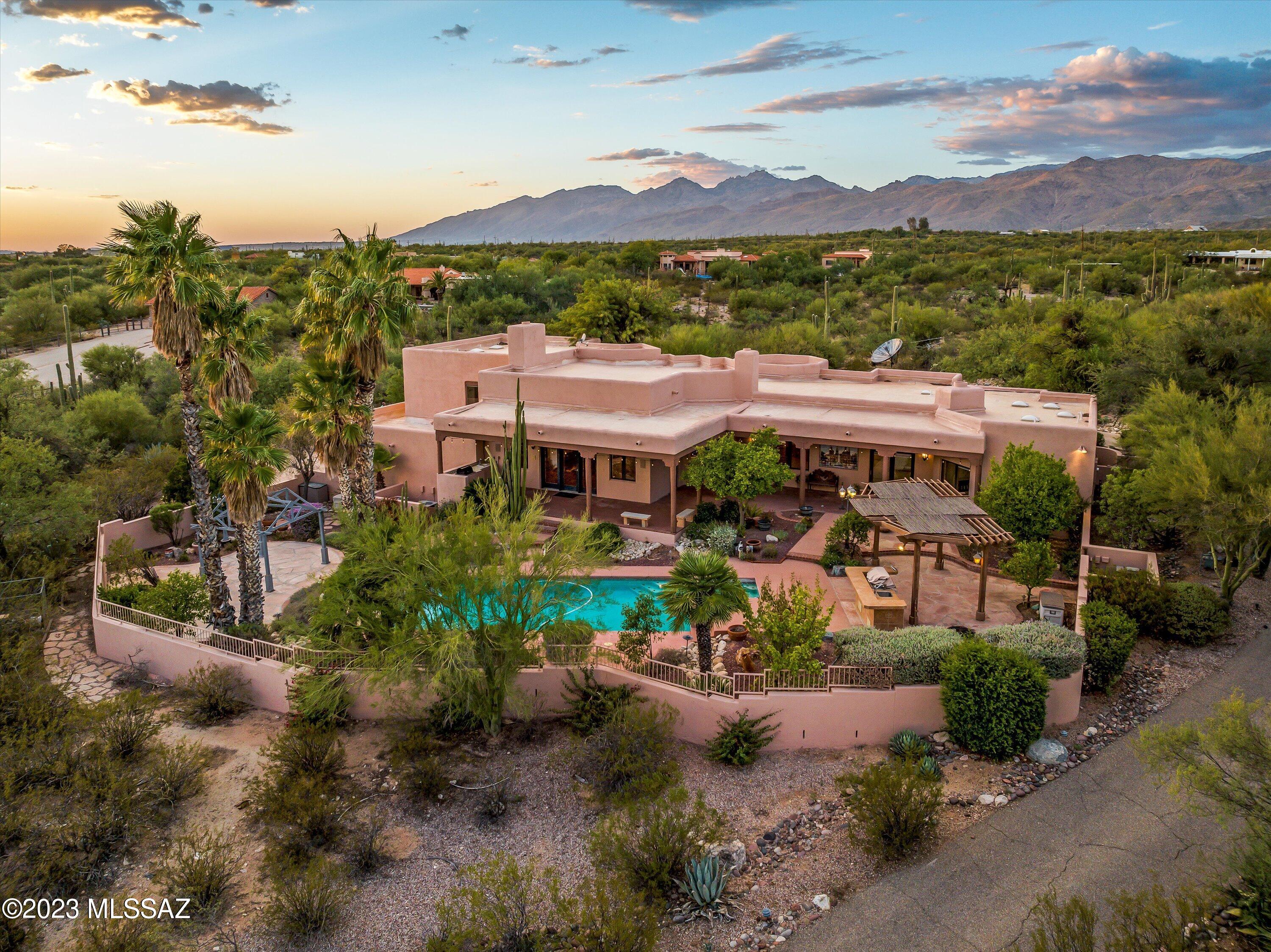 Experience luxury living in this 5-bedroom, 4-bathroom, 1.5-story home in east Tanque Verde Valley. Custom-designed by three-time ''Custom Homebuilder of the Year,'' Mike Wachs, this Santa Fe style residence offers beautiful mountain views and exquisite craftsmanship. The formal octagonal dining room sets the stage for family gatherings with large custom table and built-ins. Enjoy the romantic master suite with a see-thru fireplace. The kitchen boasts a gourmet center island with hand-made Mexican Talavera tiles. Entertain effortlessly in the beautiful backyard, complete with pool and inviting entertainment areas. The circular driveway and fountain entry add sophistication. This home is a masterpiece that seamlessly blends style, functionality, and the allure of the Tanque Verde Valley.