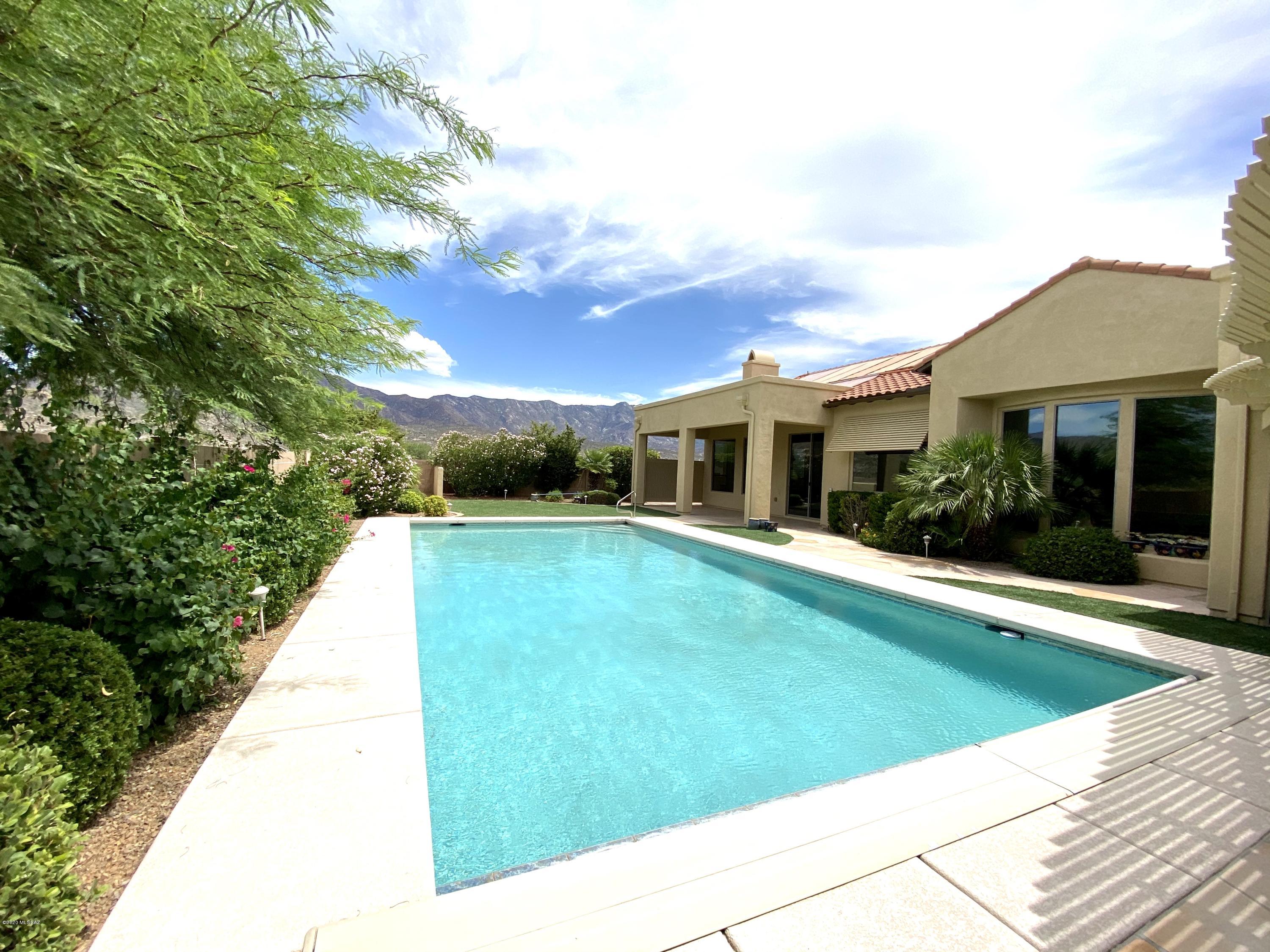 We are proud to offer an outstanding one of a kind Catalina Model modified & designed w/ 2 car side load garage & additional large 3rd car garage. Mountain Views & Crystal Blue Pool. This could be your own private resort style property located in ''The Preserve'' section of SaddleBrooke. 3 bedrooms, 3.5 baths & 2 additional rooms for you to use as den, office or quiet times. Enter inviting courtyard to view double glass french doors to spacious guest house. Custom Iron security doors leading to wide open spacious entry foyer you are greeted by floor to ceiling bay windows & views of sparkling Olympic size solar heated pool. Ceramic tile floors everywhere, chef's delight kitchen with New built-in refrigerator, gas cook top, slab granite counters & walk-in pantry.  Come visit, plan to stay.