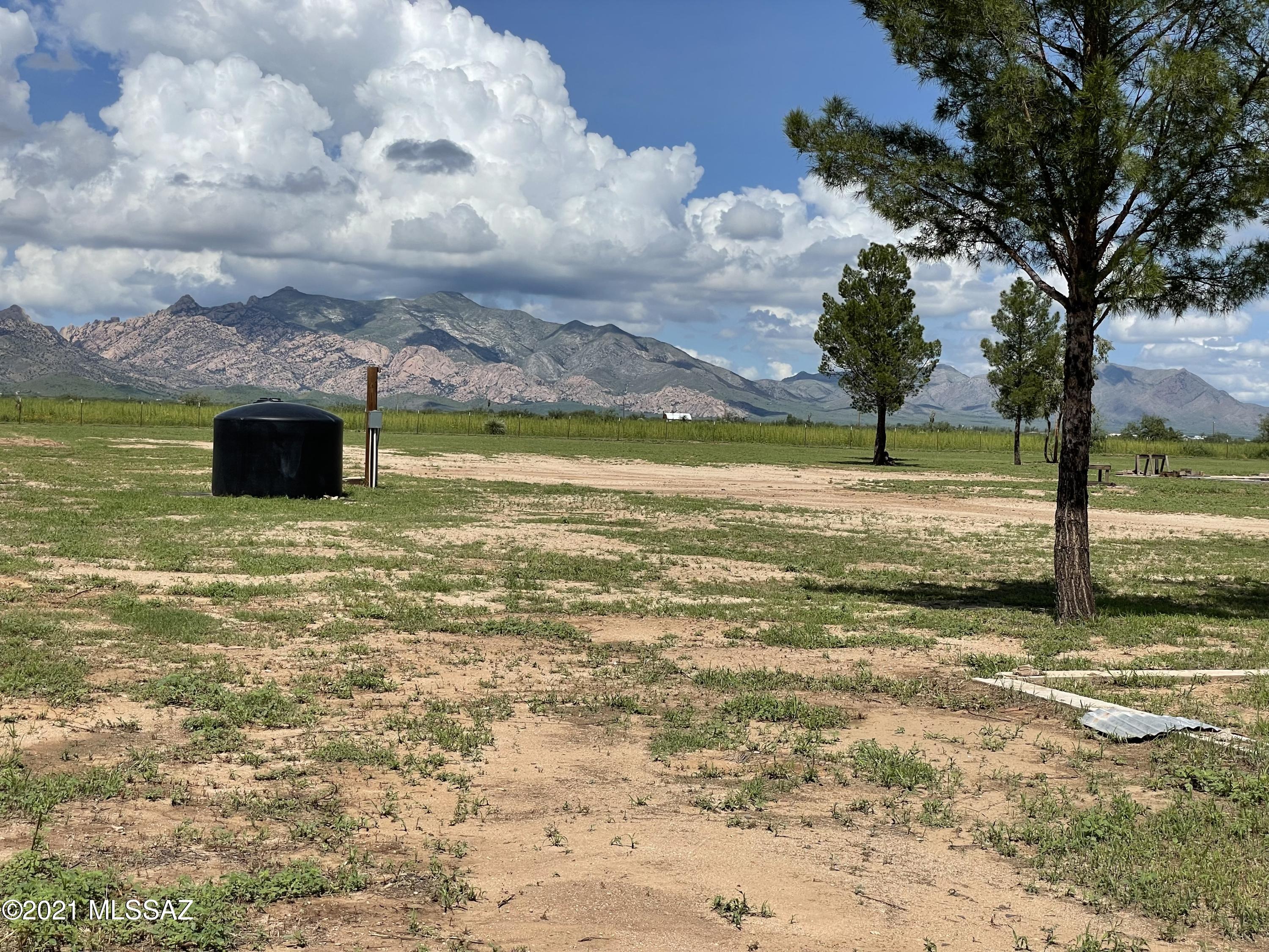 Peace & quiet, dark starry nights ,wide open spaces! Here is a fantastic 7.48 ac property that has mature trees, concrete pad from previous home & it's own PRIVATE WELL w/ 1550 gal holding tank, 200 AMP SERVICE all set up and READY TO GO!! There is appx 2.5 acres fenced with 2 gates, beyond the fencing is more adjoining acreage to the east, south and across the road to the west is 1.65 acres for added privacy from neighbors or pasture for horses/etc. 360* views, with stunning views of the Stronghold! Only minutes from the community of Sunsites and an easy commute to I-10. Sale consists of 3 parcels, two have been combined (new parcel# to come) and REZONED TO the desired RU 4 zoning! One parcel (1.65ac across rd) is zoned SR22.  Property is all ready for your site built home!!