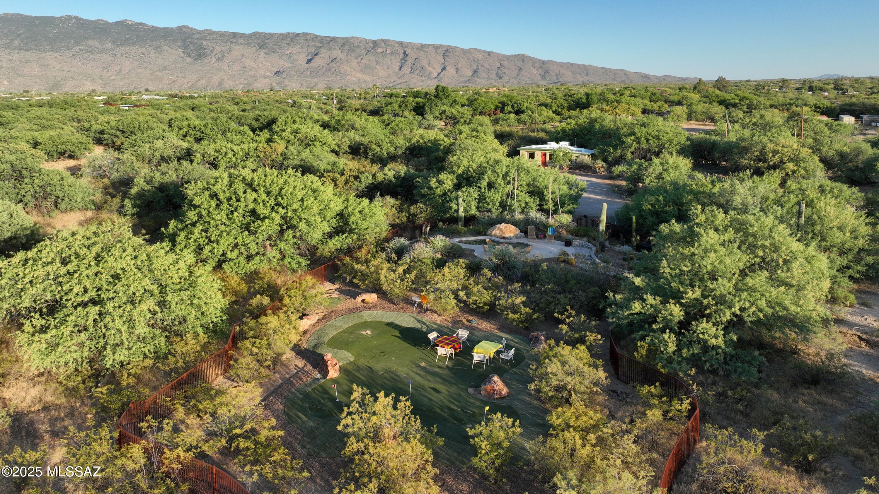 Discover a rare opportunity in NE Tucson's coveted Tanque Verde Valley with this captivating property, nestled on a sprawling 6.7296-acre parcel enveloped by a mature mesquite bosque & offering stunning mountain views. This meticulously maintained estate features 4 charming masonry casitas, each with its own distinctive character, adding to the overall allure & appeal of the property. The largest is a spacious 2-BR, 2-BA casita, perfect for comfortable living. Accompanying this main residence are 3 additional casitas, each offering 1-BR & 1-BA. This layout provides versatile options as a wonderful & hard to find  family compound or as a rental property. The property boasts a long rental history. It is privately gated with easy access from a paved road offering convenience and security. The property is subdivided into two 3.3+ acre parcels and sold As-Is. It can possibly be sold as two separate 3.3 acre parcels with 2 houses on each. New address and tax parcels from Pima County still to come. 
Nearby amenities include renowned restaurants, golf courses, hiking trails, the Tanque Verde Guest Ranch, Saguaro National Park, Coronado National Forest, shopping and medical facilities, enhancing its appeal as both a residence and a rental property. The land also offers other spectacular homesite locations if the new owner would like to choose one to build a larger residence. Call for details. 
Enjoy the serene outdoor setting from the centerpiece of the property - a sparkling spool (a combination of a spa and a pool) perfect for relaxation amidst the natural beauty of the massive mesquites and incredible mountain views. A private, separate laundry building ensures convenience and efficiency for both residents and their guests.
The property's turnkey option adds exceptional value, as it includes all furnishings, linens, kitchenware, TVs, BBQs, and more with a full-price offer. 
Embrace the great Tucson climate and the tranquil rural setting of the Tanque Verde Valley, where open spaces, extreme privacy and natural beauty converge to create an unparalleled living experience.
Whether you seek a peaceful retreat for yourself and your family or to invest in the growing Tucson market, this property offers the perfect blend of charm, comfort, and potential in one of Arizona's most sought-after locations.