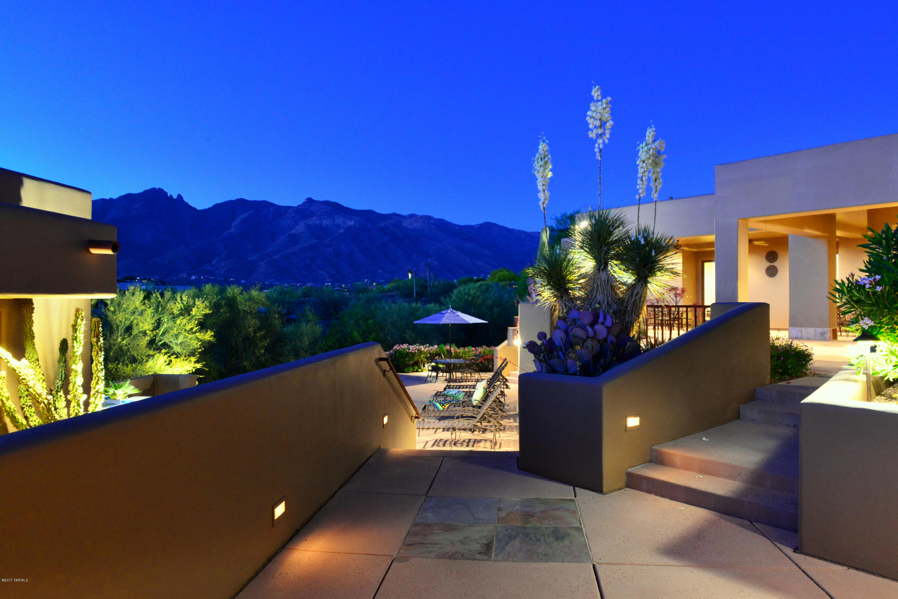 Catalina Mountain views and fabulous AZ resort-style living in serene gated community near famed Hacienda Del Sol Resort! Prime Foothills location on elevated cul-de-sac lot in private Colonia Del Sol. Traditional SW contemporary designed by famed Tucson architect Ron Robinette with 6BD, 5.5BA and den in main house with separate guest wing plus GH. Upgraded chef's kitchen with Sub-Zero & Thermador appls and soft-closing cabinets. Split layout provides privacy for Master Suite & Den. Cream marble floors, beamed ceilings, skylights, oversized 3-car garage. Large covered patio with BBQ kitchen overlooks resort-style pool & spa area. Guest House with kitchenette, full bath & Murphy bed is perfect rec room, home office or extra BD. Enjoy patios on 3 levels for mountain and city views. Gorgeous!