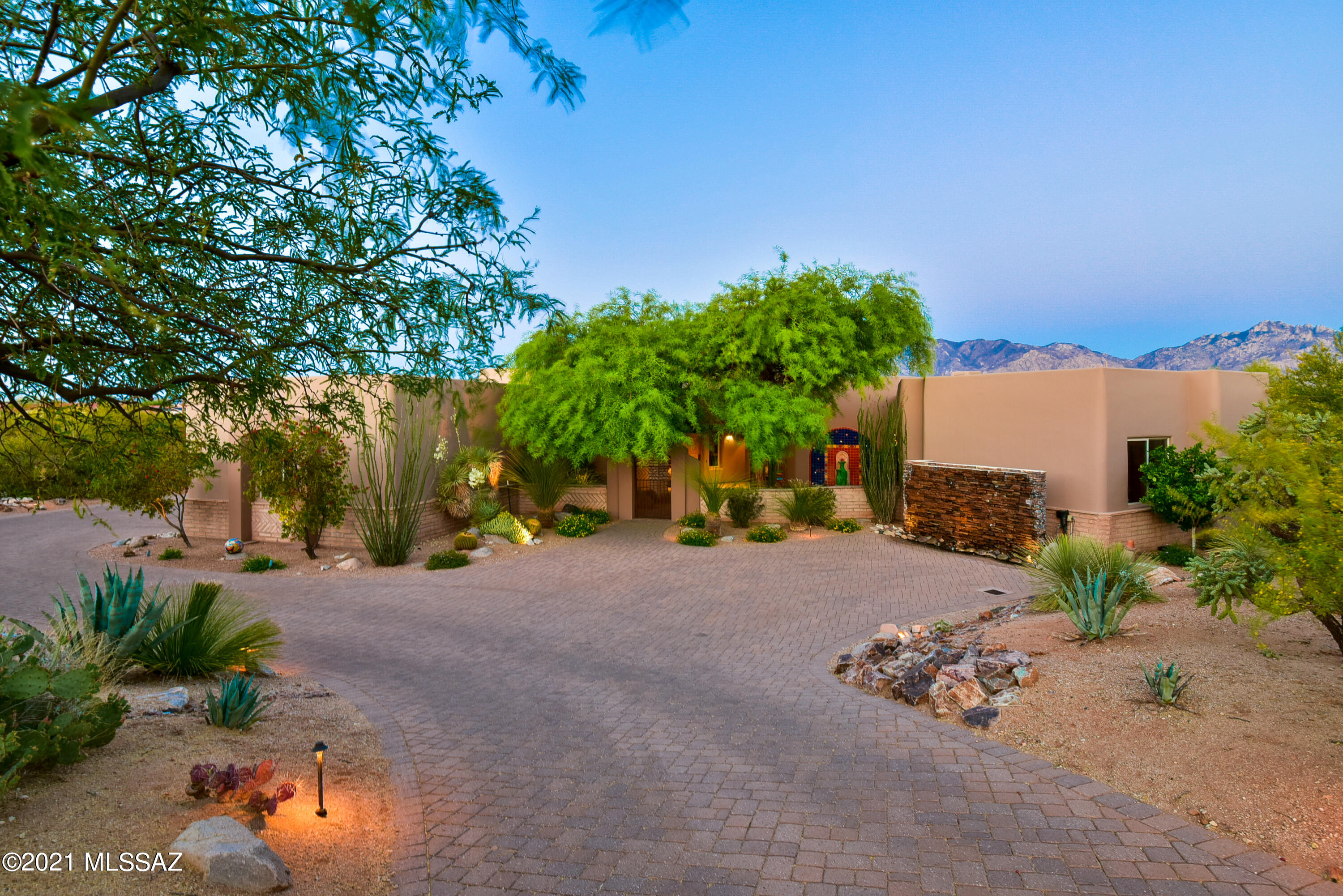 Arizona living at it's finest. Elegant custom home in guard gated Honey Bee Ridge. 5 en-suite bedrooms in split bedroom floor plan. Great room has dramatic floor to ceiling fire place & windows framing spectacular Catalina Mountain views. Grand gourmet kitchen with granite counters, alder wood cabinets & island breakfast bar, dbl ovens, warming drawer, etc. Master bedroom mountain views, a sitting area w/ fireplace, luxurious bath & spacious walk in closet. Charming   2 room + bath Casita w/private patio, water feature & fire pit. Patios w/3 water features, citrus trees, solar heated spa, salt water pool w/ boulder water water fall, & romantic fire pit. Covered/heated kitchenette w/bar, water, fridge &  gas grill.  Minutes to Stone Canyon Golf & other courses. Amenities list in documents