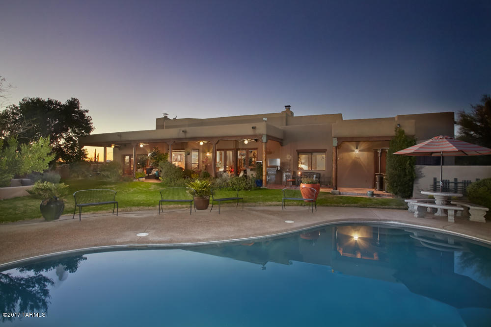 Enjoy the finest in Southwest living in this stunning home with wonderful views, horse facilities, private gated entry & charming brick courtyard. This 5.15 AC property affords all of the luxury amenities to please the most discriminating buyer. With 4 BRs, den, family/media room, this spacious home features Saltillo tile floors, high plank & beamed ceilings, decorative tile & saguaro rib accents, lots of built-ins & niches. State-of-the-art kitchen boasts hand-crafted cherry & oak cabinets, built-in refrigerator, SS appliances, granite countertops, & breakfast area w/bay window overlooking the patio. Split master suite has new wood floors, fireplace, and lavish master bath. The lush rear yard is a showplace with huge back patio, built-in BBQ, cozy FP area, pool/spa, privacy & great views. Horse facilities include 2 stalls with turnouts, arena, & storage sheds.