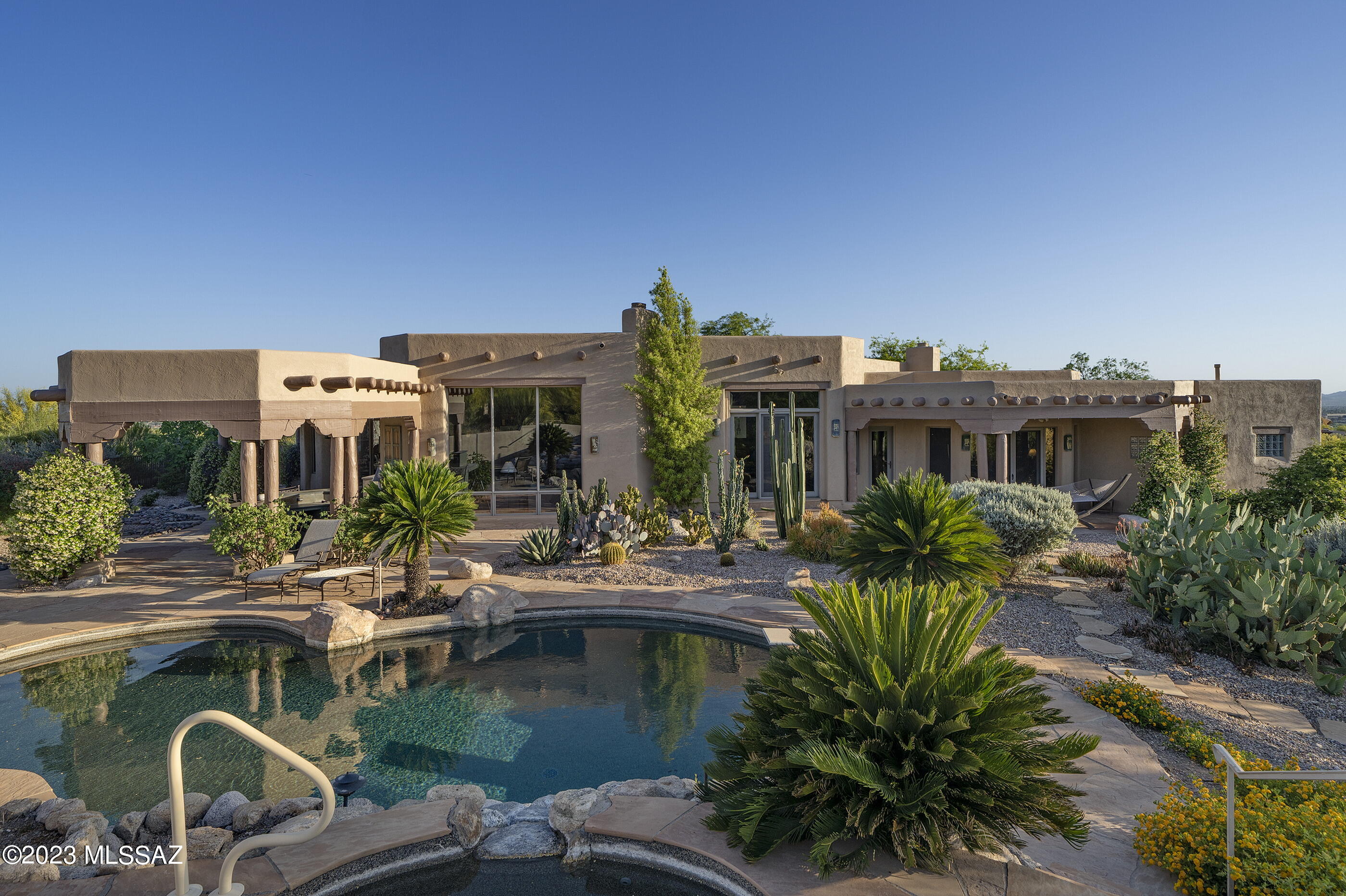 Contemporary Santa Fe by Ron Robinette. Richly Authentic, Unparalleled Quality & Craftsmanship. Updated to Perfection.  Sweeping Mountain/City Views.  Lofty Vega Beam Ceilings, Wall-to-Wall Flagstone, Floor to Ceiling Wood Cased Windows, Knotted Hickory Cabinetry, Granite & Mesquite Surfaces, Intricately Crafted Rock Fireplaces, and Finishes that stand up to the most discriminating scrutiny.  State-of-the-Art Kitchen w/ Gorgeous Island, Wolf Apls, Enviable Breakfast Rm and Picture Window that Frames the City below.  Secluded Owner's Suite w/ FP, 2 Closets and Remodeled Bathroom by Rochelle Rubin.  Gracious Courtyard, Eye Catching Front & Back Elevations, Deep Overhangs, Sprawling Patios, Salt Water Pool & Spa.  Shows like New!  See List of Seller Improvements.  Most Furniture Available.