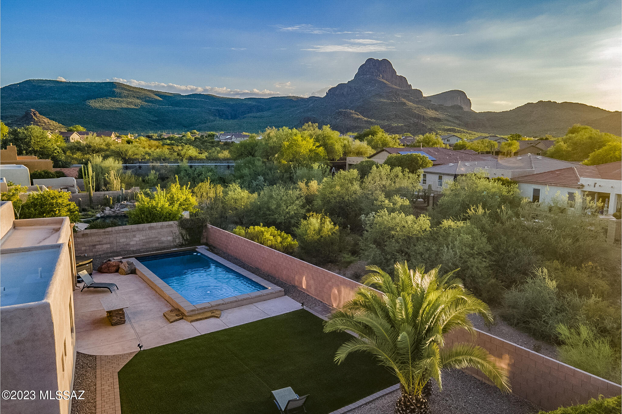 Located in Continental Reserve, 8107 N Night Pony Drive blends a setting that showcases the beauty of the desert with community living, proximity to amenities and easy access to roads for commuting. Situated on a large, private pie-shaped lot with open space behind, you will find compelling views of the Tucson Mountains and incredible sunsets. Outdoor living is at the forefront here. The generous custom designed ozone pool includes both elevated zones for relaxing or play, along with deeper water and a swim lane for laps. Additionally, residents will enjoy a separate hot tub, built in speakers, an outdoor kitchen with pizza oven, and multiple zones for seating and gathering. A Santa Fe style exterior with wood beams and clay sconces feels authentically Southwest. The home is set back from the road nicely with an extended driveway, creating plentiful parking for guests.

Inside, the open layout features high ceilings in the great room and large windows letting in ample light. The chef's kitchen includes granite counters, a built-in wall oven, pull outs in lower cabinets, reverse osmosis, and a gas cooktop. A sliding door in the primary suite provides quick access to the outdoors and mountain views are enjoyed from this space. The home is kept cool with a new, high end HVAC system (installed in 2022).

The Continental Reserve neighborhood offers residents many wonderful lifestyle elements. Sidewalks are available for walking and in just a couple of minutes you will reach the Passey Loop Trail for a scenic and easy hike. Under a mile away sits the elementary school and community park that includes ball and soccer fields, a tennis/pickleball court, basketball court, playground and ramadas.

Outside the neighborhood, conveniences galore are available. Within 5 minutes there is a wide variety of retail, grocery, restaurants, fitness facilities, movies, golf, a dog park and more. For walkers, runners & cyclists, access to "The Loop" 135-mile paved multi-use path is 1.5 miles away. Equestrian lovers will find several different stables in the area for riding & lessons, while hikers and mountain bikers have the Tucson Mountains at their fingertips. Traveling to Tucson's major employers is made simple with quick and easy access to I-10.