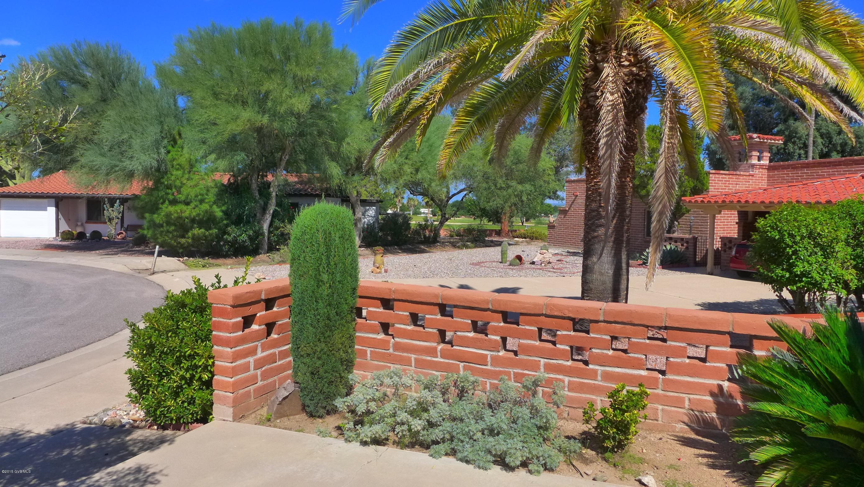 This delightful home will make you smile. It's clear its been well loved and beautifully maintained. A glassed in AZ room w/split unit adds bonus square footage and will probably become your favorite spot if you decide to make this special place ''home''. All of the main living areas flow seamlessly together. The rooms are spacious and large windows and added solar tubes in all the right places ensure they are full of light. Homeowner has put new floors in the kitchen/family room area, AZ room and master bath. The oversized backyard is surrounded by lush vegetation and backs to a large arroyo. There are large patios making outdoor entertaining a breeze.