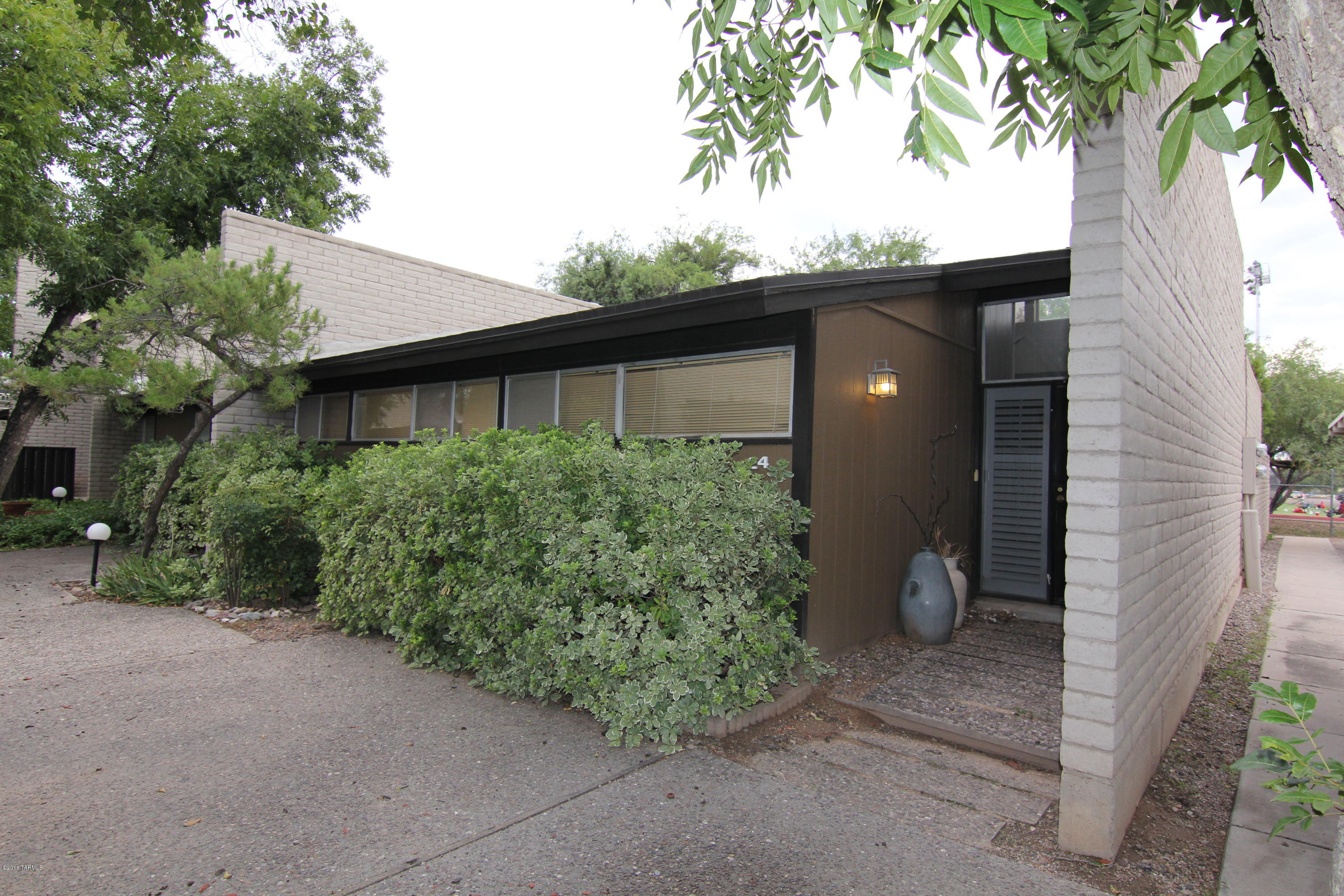 Home Sweet Home, this end unit is tucked into the back corner of the complex
& offers mature shade trees. Nice backyard space for relaxing or entertaining. Spacious living area, vaulted ceilings, large master & secondary bedroom with 2 full baths. Master has 2 closet spaces! 2 covered parking spaces very close to unit. Freshly painted interior & carpet has just been installed! Location is great near many amenities & steps away from Ft Lowell Park. HOA Fee covers ALL WATER, Common Areas incl pool w/solar heat
open year round based on personal comfort, insurance for common areas & some structural on unit, maintains
covered parking, sheds & fences, ext. paint on unit.