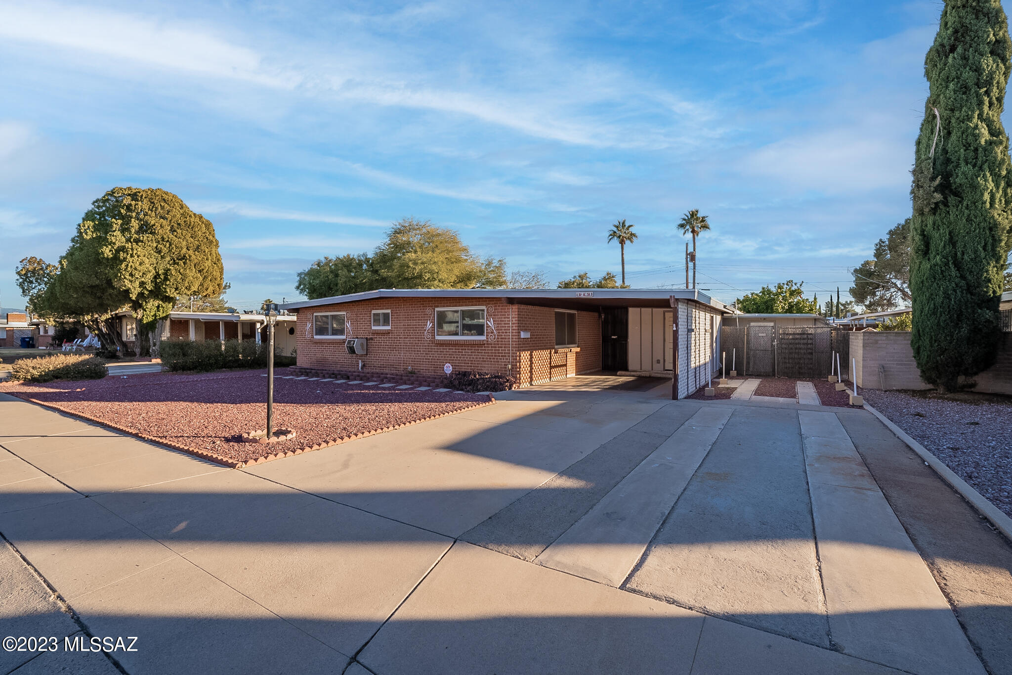 Lovingly owned for almost 45 years by the same owners, now available for you to come and make it your own. Great brick home with Catalina mountain views from the front yard. Carport and extended driveway has plenty of room for multiple vehicles. No HOA means your toys can be right with you. 4 bedroom 2 bath over 1900 sq ft. Bonus family room off of kitchen. If you love to tinker on projects, then the extra workshop and storage shed will have you handling all of your hobbies with plenty of room. HVAC only 2 years old, water heater 1 year old. Full covered back patio with roomy backyard includes fruit trees. Close to freeway, shopping, restaurants and only 10 minutes from the U of A. Being sold As-Is.