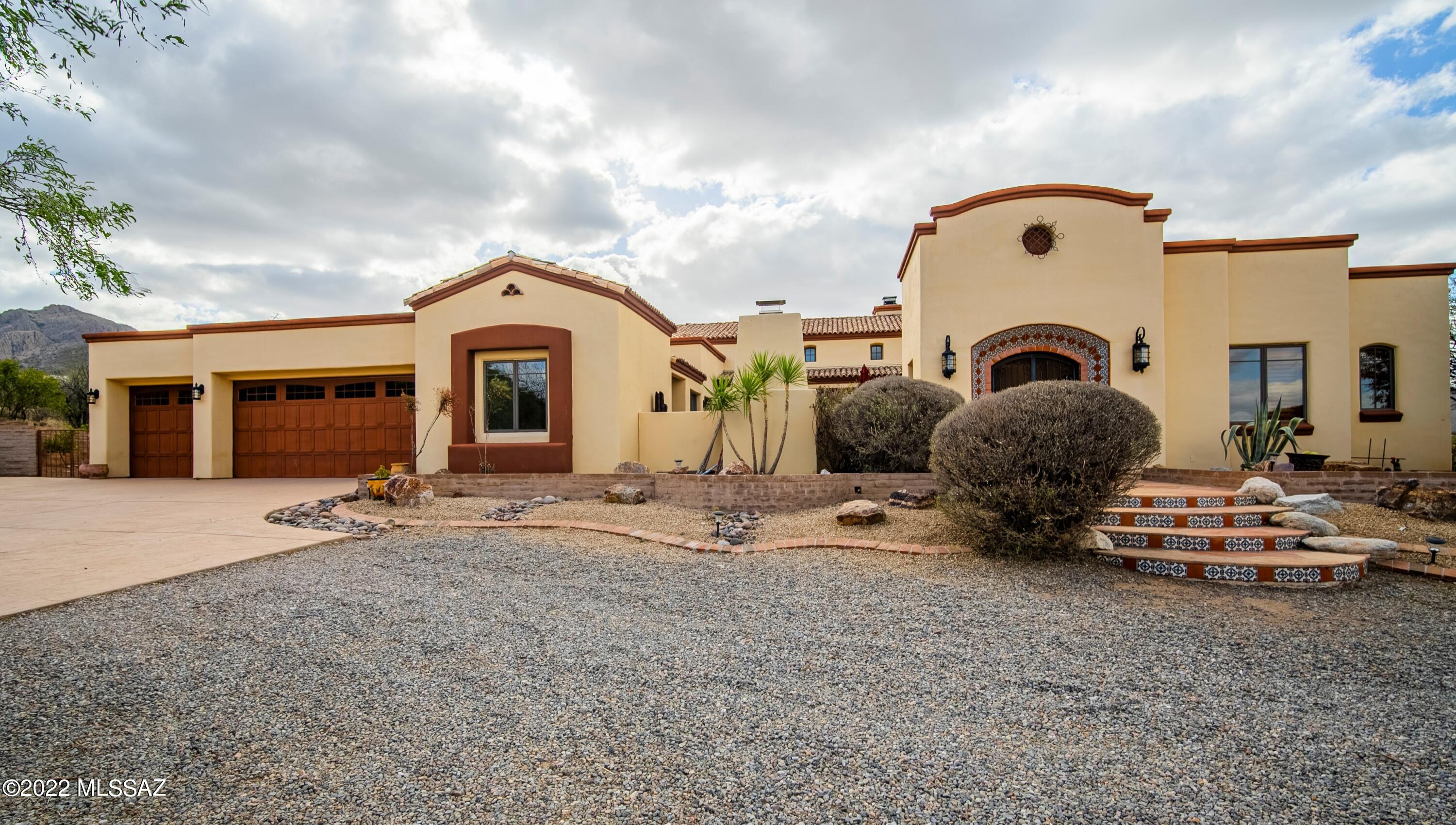 Nestled at the base of the Tumacacori Mountains, this amazing custom home has splendid views through every window.  The considerable great room delivers a wide-open feeling with suspended wood trusses, eye-catching chandeliers, a remarkable floor-to-ceiling river rock fireplace and a triple set of 6-panel glass French doors on each side.  Your chef's dream kitchen has a massive granite covered island with a convenient prep sink, striking alder cabinetry with travertine tile backsplash, a professional grade double oven range and a country style farmhouse sink.  Elegant meals are served under a decorative recessed ceiling where guests can enjoy mountain views in one direction and courtyard views in the other direction.  After dinner, retreat to the exquisite family room where a bank of solid pane windows will capture your attention with views of desert vistas and rugged mountain edges.  The owner's suite has wood plank flooring and a French door for patio access.  Bathe yourself in luxury in your corner soaking tub where majestic views stream through an array of corner windows.  Separate "his and her" vanities combine with a corner makeup station to give you privacy and extra elbow room.  The separate casita creates a special place for overnight guests to enjoy opulent living with travertine, granite and alder cabinetry finishes.  Specular outdoor living areas on 7.2 acres with multiple patios and of course, a spectacular pool and spa!  A dream home in a dream location!