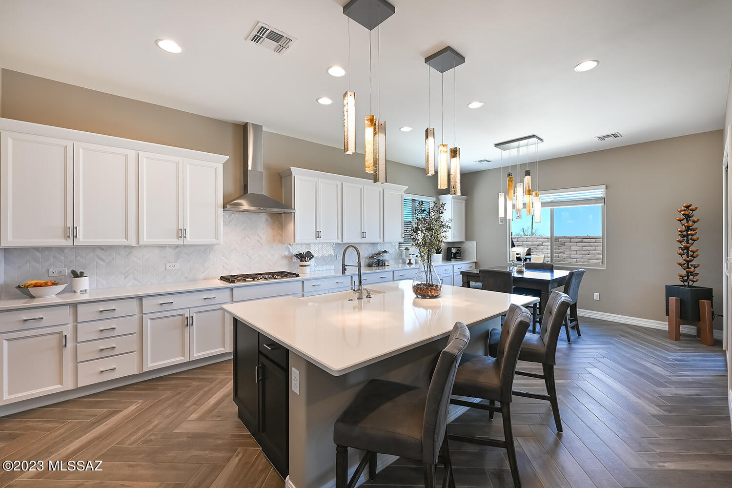 Within this gated community, you can experience a higher level of luxury living w/unrivaled amenities & sophistication -an extraordinary home. Gourmet kitchen features Café Series stainless appliances w/copper accents, dual convection ovens, quartz countertops, extended cabinetry, and a stylish butler's pantry. Interior upgrades include coffered ceilings, herringbone wood plank tile flooring, and multi-panel sliding glass doors for seamless indoor-outdoor flow. 2 primary en-suites offer spa-inspired luxury, while all bedrooms have walk-in closets. Outdoor living shines with a custom heated pool, spa, fire pit seating, and Smart IntelliCenter controls. Additional features include a central vacuum system, split-system dual A/C, epoxy garage flooring, and a stunning glass/metal front door.