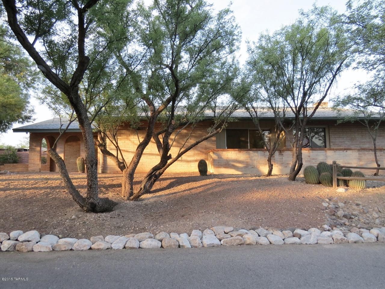Perfect Location! Great home! Beautiful grove of shady trees set well back off of Wrightstown Road. Front and side patios with Catalina views through the trees. Large Burnt Adobe home featuring 3 bedrooms with large open living area plus the Family Room off the kitchen area. Beautiful beamed ceilings in the Living Room and the Dining Room. Gas log fireplace in the Family Room. Enjoy the serenity of this quiet secluded neighborhood. Close to shopping and dining!