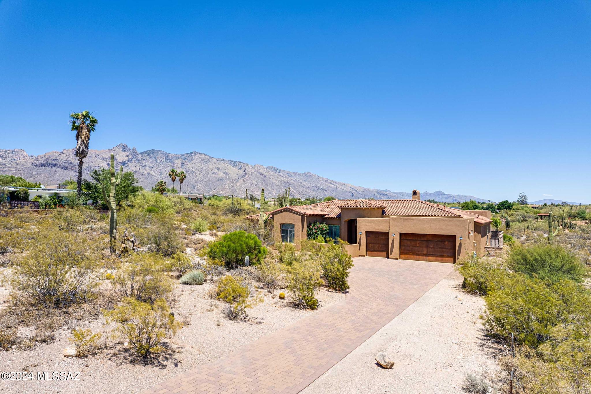 Desirably located A.F. Sterling custom home built located in Catalina Foothills Estates. Huge mountain and city views. Close to shopping and restaurants at La Encantada. Built in 2015. Interior include custom features gormet kitchen with quartz countertops, shutter window coverings, large master suite, three car garage, and so much more. Entertainers backyard with large covered patio, artificial turf, and easy care backyard with pavers and artificial turf.